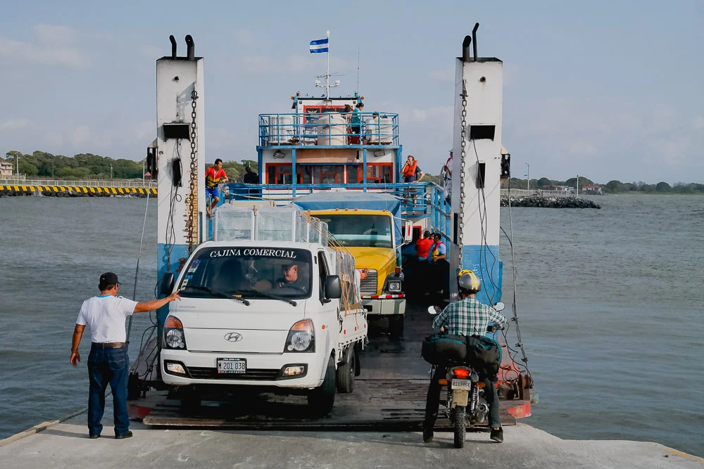 two trucks, three cars and a motorbike all fit on this tiny ferry...