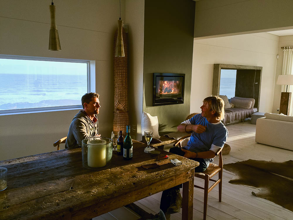 Rufus and Jochem relaxing in front of the fire, overlooking Yzerfontein beach