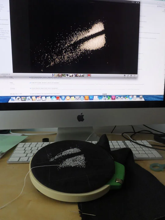  photo of salt on a black piece of paper, shown on my mac in iPhoto, while I stitch to replicate the marks (sort-of). I took pics of salt on a black background earlier last year, and now I'm stitching more of those images.