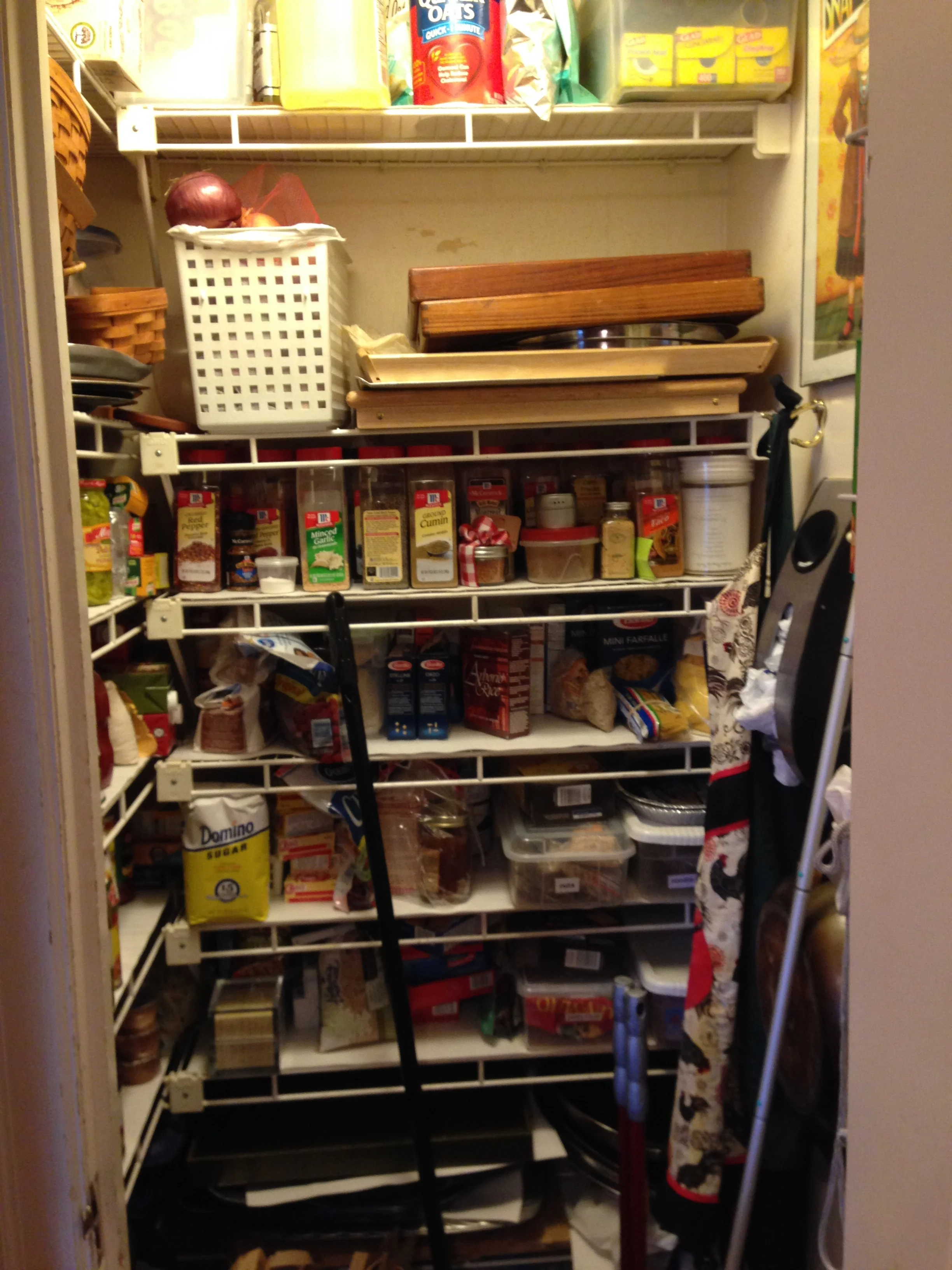 This is my old pantry - I hated the trays all stacked on each other and the overhang on the shelves. It was so hard to see what I had and what I needed to buy. Can you see the peeling paint? Ick.