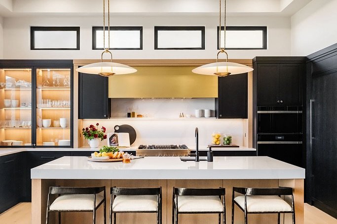 Lights on, light off. 
Revealing the gorgeous kitchen at our Elderberry project. This kitchen has it all- stunning white oak cabinetry, custom brass range hood, hidden butler&rsquo;s pantry, thickened island counter, high end appliances, transom wind