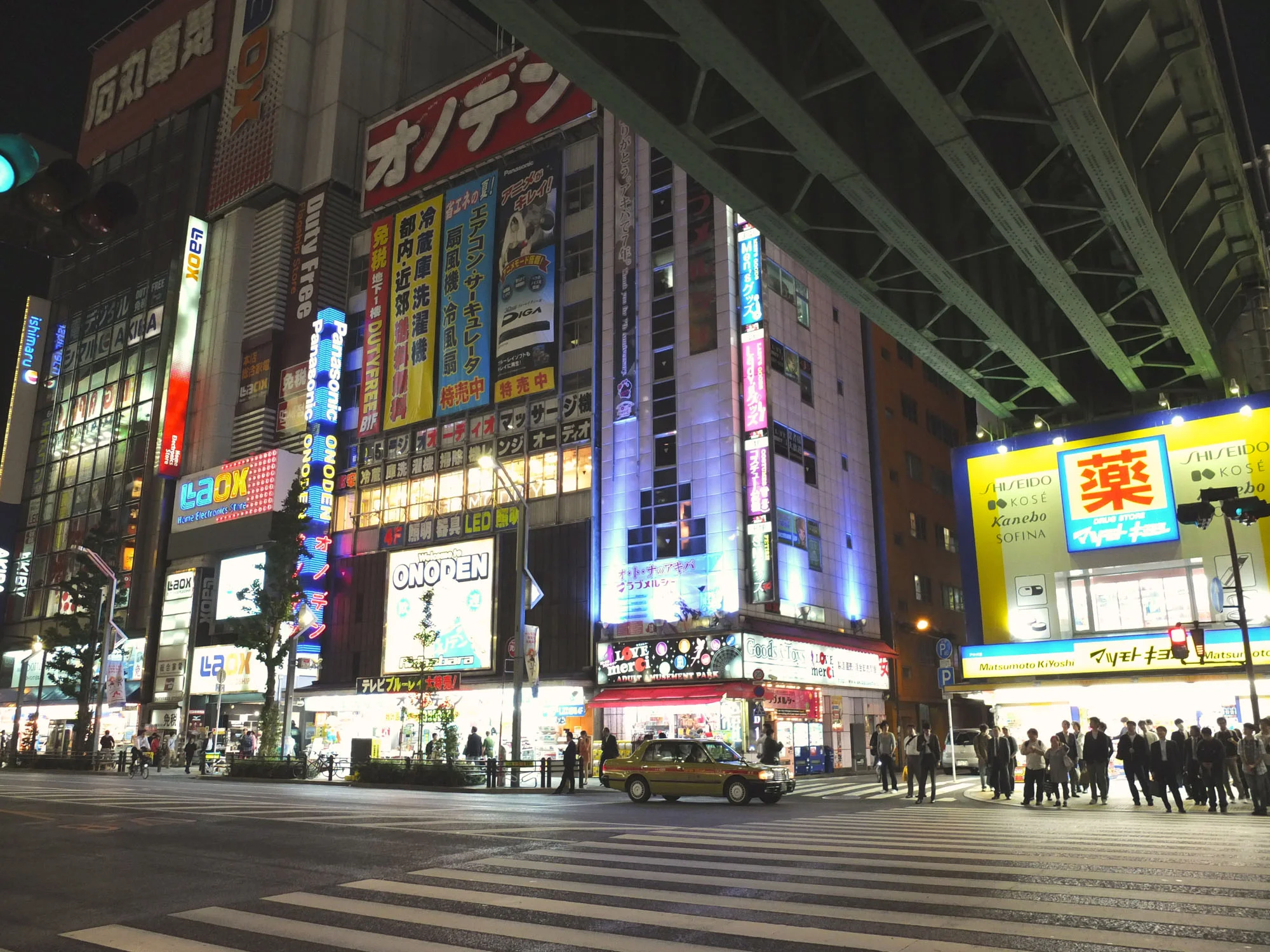 Walking through the streets at night holds its own kind of beauty with bright lights and busy streets.