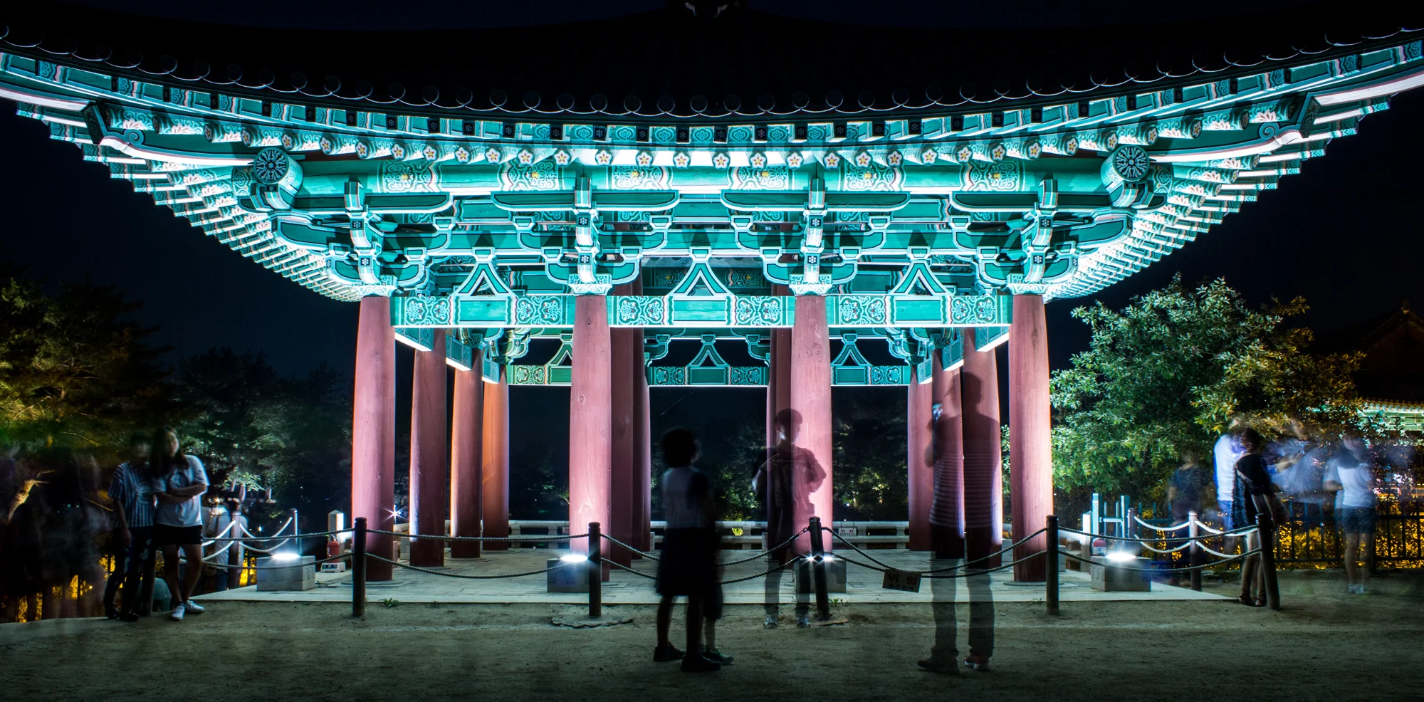 Tourists pause for photos at one of the three rebuilt structures.