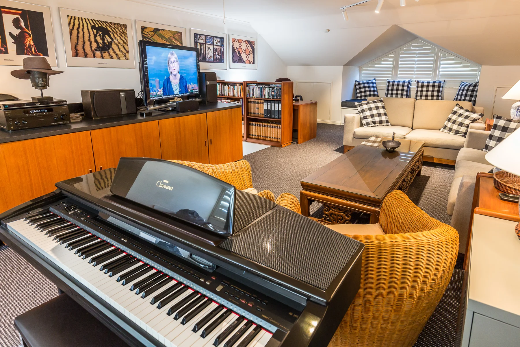 The upstairs loft with piano, flat screen TV and lounge.
