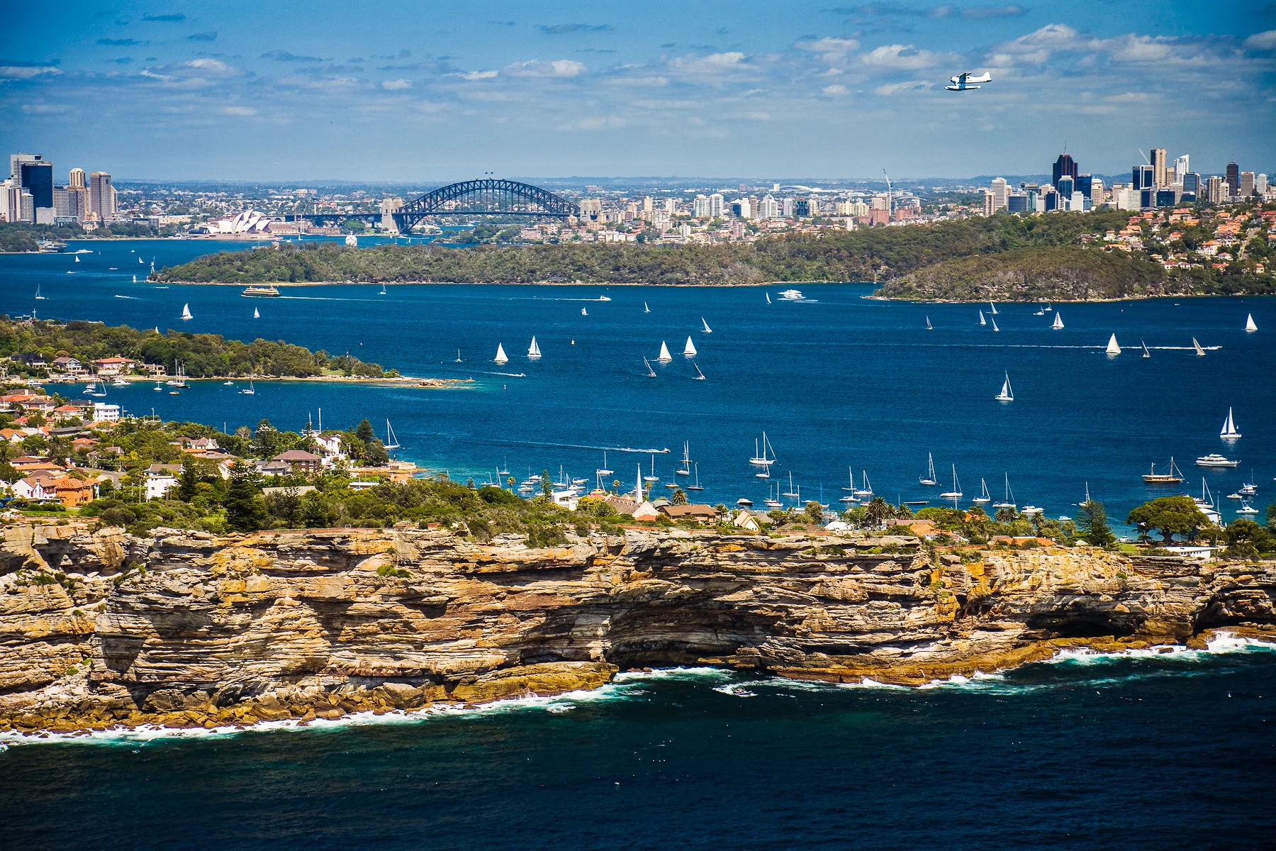 View of South Head in Sydney with a seaplane about to land.