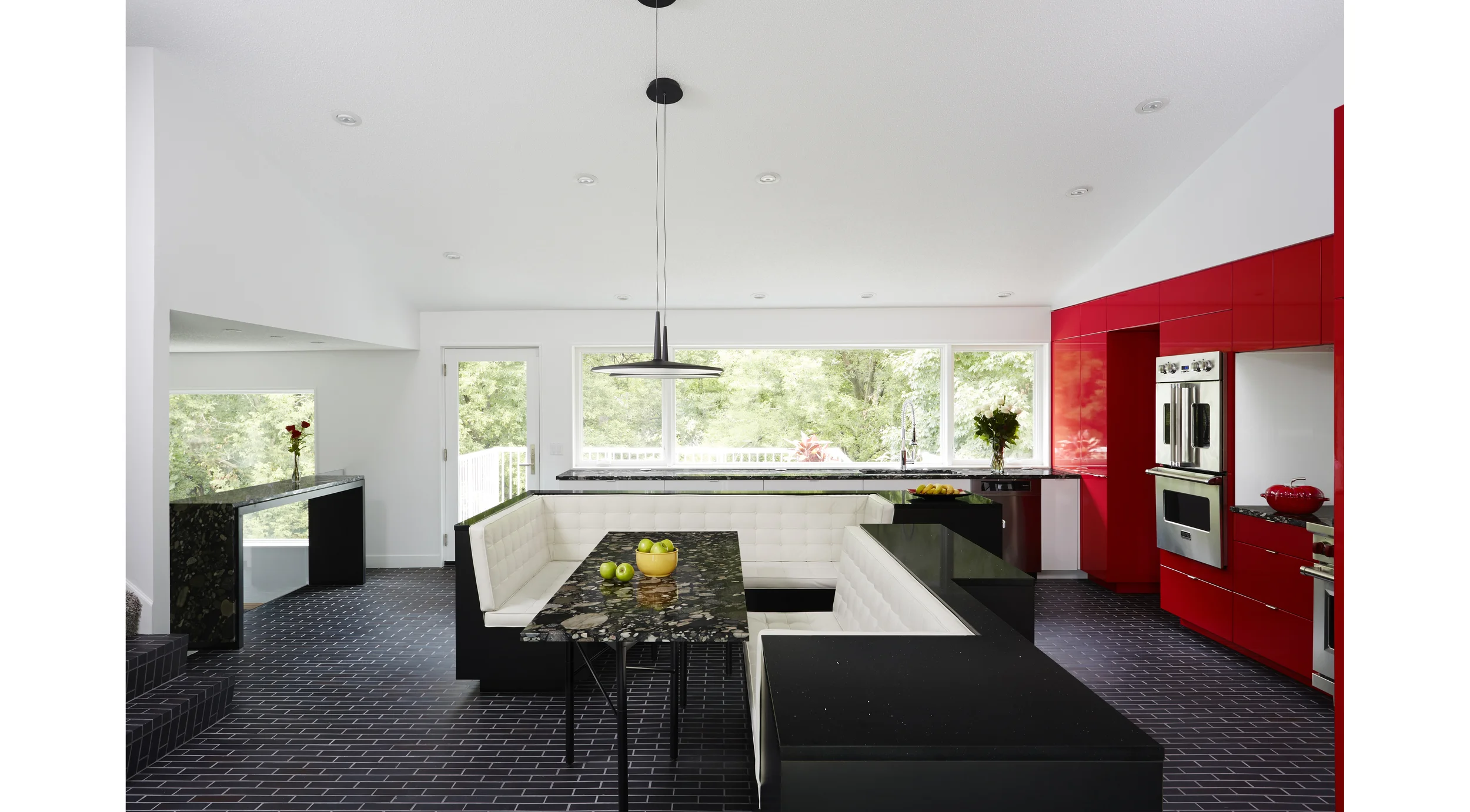 The Gathering Kitchen - re-placing eating at the center of the home. We’ve all had the common experience of guests gathering in the kitchen. It seems the kitchen has replaced the hearth as the center of the modern home. Often in this shift is the loss of gathering around the table. This client has a passion for cooking and has lived for 20 years with a kitchen that’s fallen short of her needs, and a dining room that is never used. She also has a passion for hosting her family & friends – large groups, lively and animated! We combined the space of both rooms to make one large gathering kitchen. The centerpiece is the island which was split open and pulled apart to make place again for gathering around the meal. The island provides functioning countertops and ample storage, as well as enclosure for the full dining table. An adjustable 6-legged table base, as well as unique Marinace granite, cherry red cabinets, and Manganese Ironspot brick highlight the material palate. Photographer: Alyssa Lee www.alyssaleephotography.com Project Team: Ben Awes AIA, Principal-In-Charge Bob Ganser AIA Nate Dodge
Normal
0
false
false
false
EN-US
X-NONE
X-NONE
/* Style Definitions */
table.MsoNormalTable
{mso-style-name:"Table Normal";
mso-tstyle-rowband-size:0;
mso-tstyle-colband-size:0;
mso-style-noshow:yes;
mso-style-priority:99;
mso-style-parent:"";
mso-padding-alt:0in 5.4pt 0in 5.4pt;
mso-para-margin-top:0in;
mso-para-margin-right:0in;
mso-para-margin-bottom:10.0pt;
mso-para-margin-left:0in;
line-height:115%;
mso-pagination:widow-orphan;
font-size:11.0pt;
font-family:"Calibri","sans-serif";
mso-ascii-font-family:Calibri;
mso-ascii-theme-font:minor-latin;
mso-hansi-font-family:Calibri;
mso-hansi-theme-font:minor-latin;}