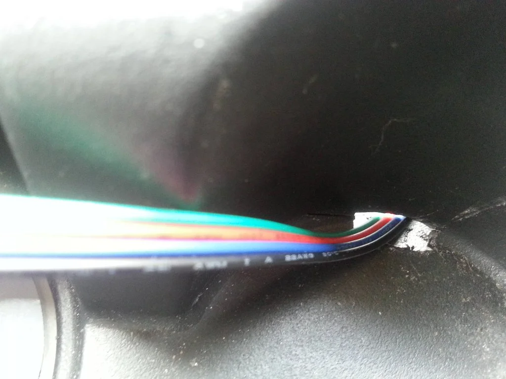 Hole cut in passenger side cupholder.