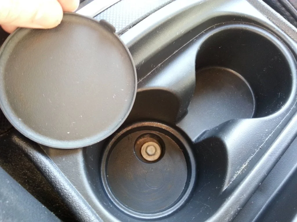 OEM bottom cupholder pad removed.