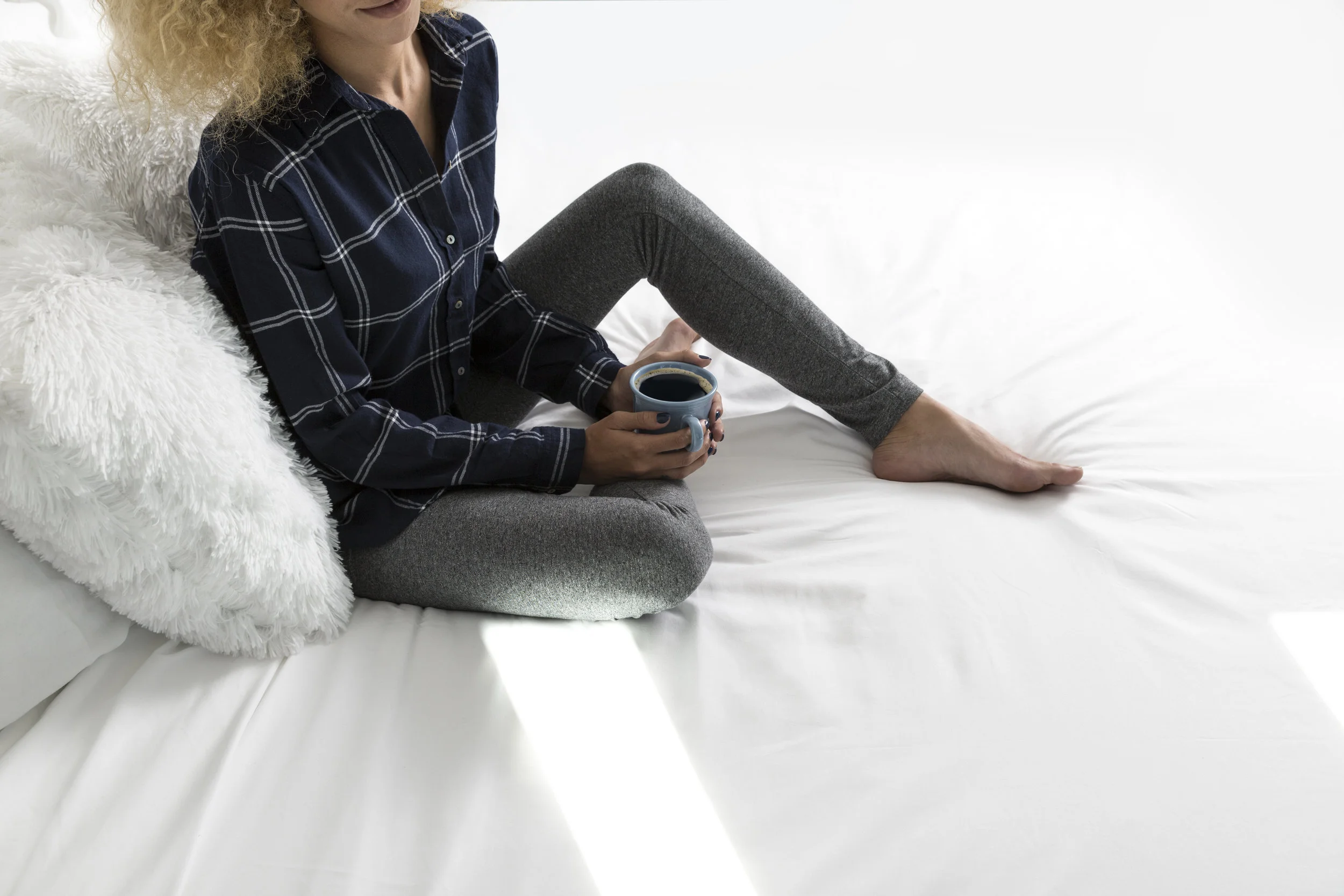 Woman drinking coffee on bed for S’PARK in Boulder, Colorado by Rebecca Stumpf Denver Boulder Colorado Editorial and Commercial Lifestyle Food and Travel Photographer