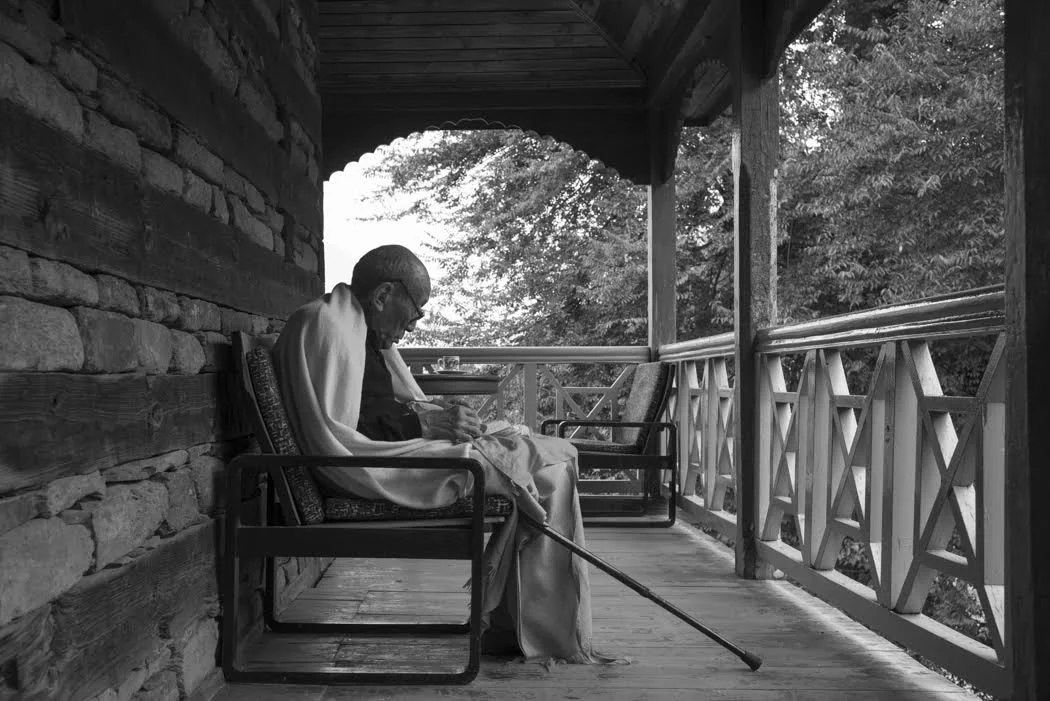 Rinpoche says his own prayers on his verandah