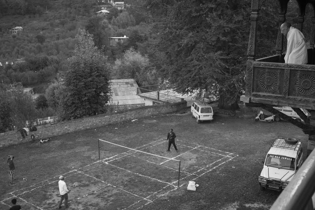 and peers over to watch the badminton games