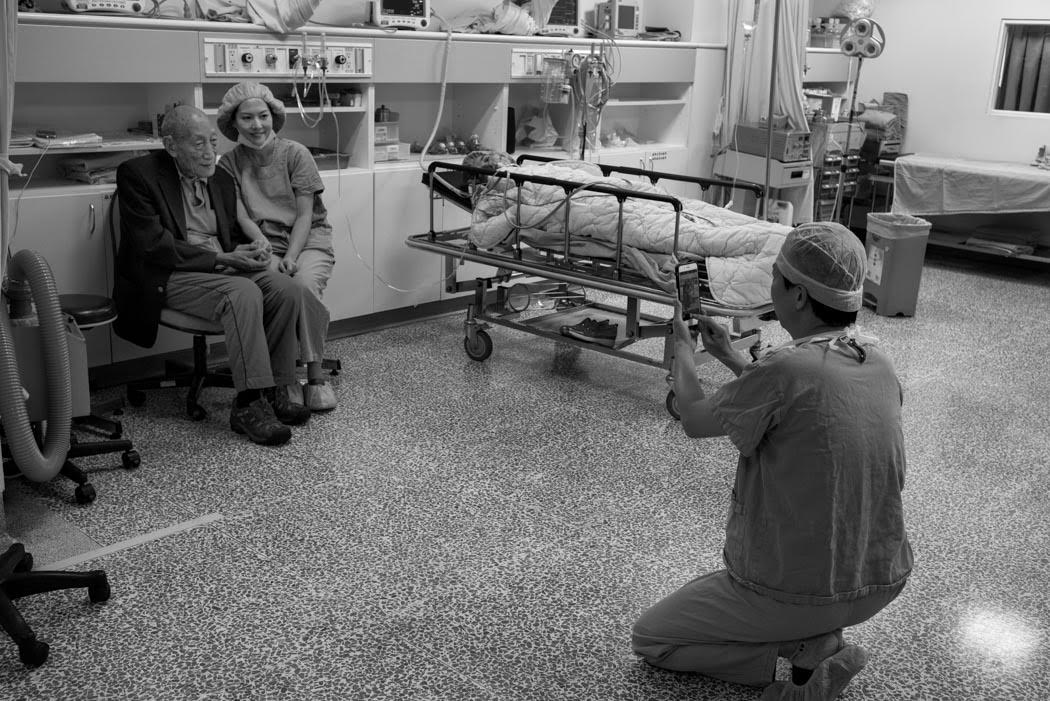 And to see Dr. Li who photographs his assistant with Rinpoche as a patient looks on