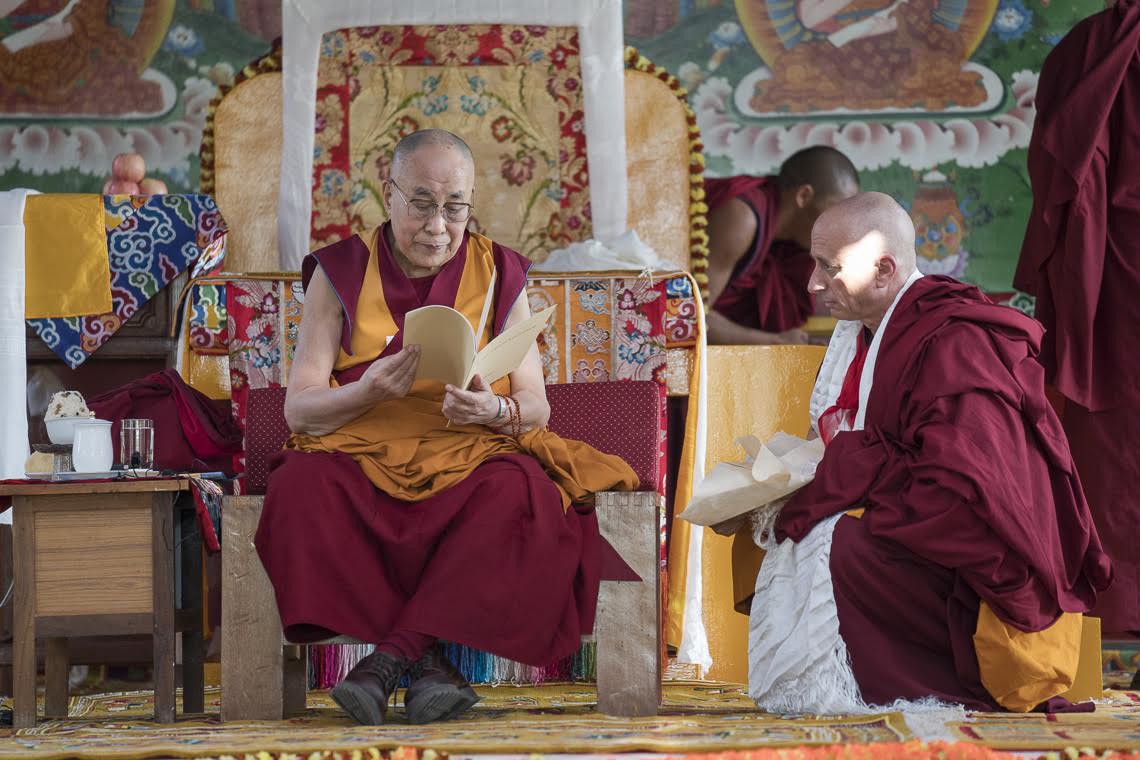His Holiness examines the new Rato Chayik Chenmo—Great Constitution of Rato Monastery—which he composed. Photo by Tenzin Choejor—OHHDL