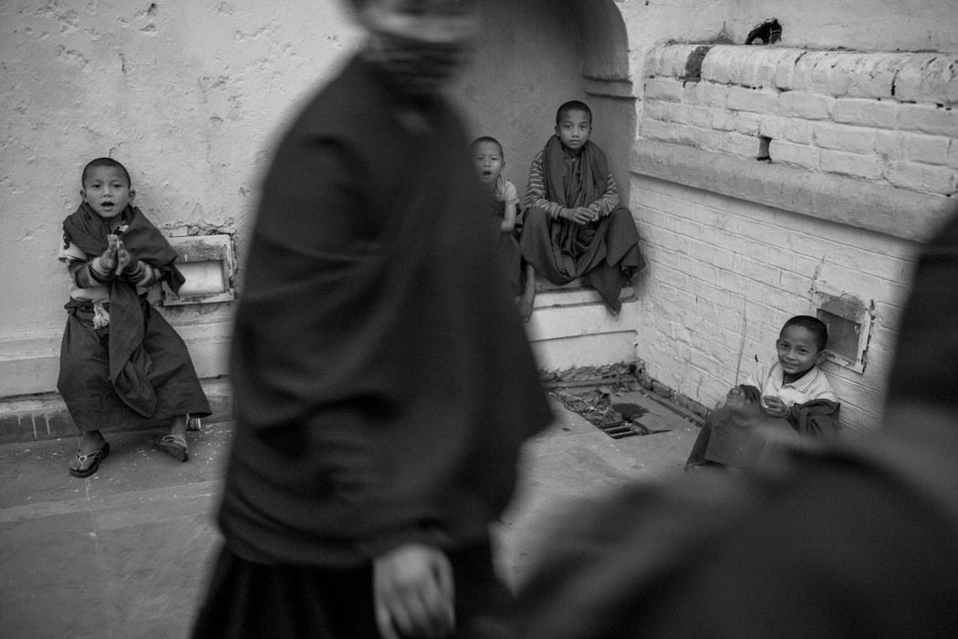 Young monks pray, play