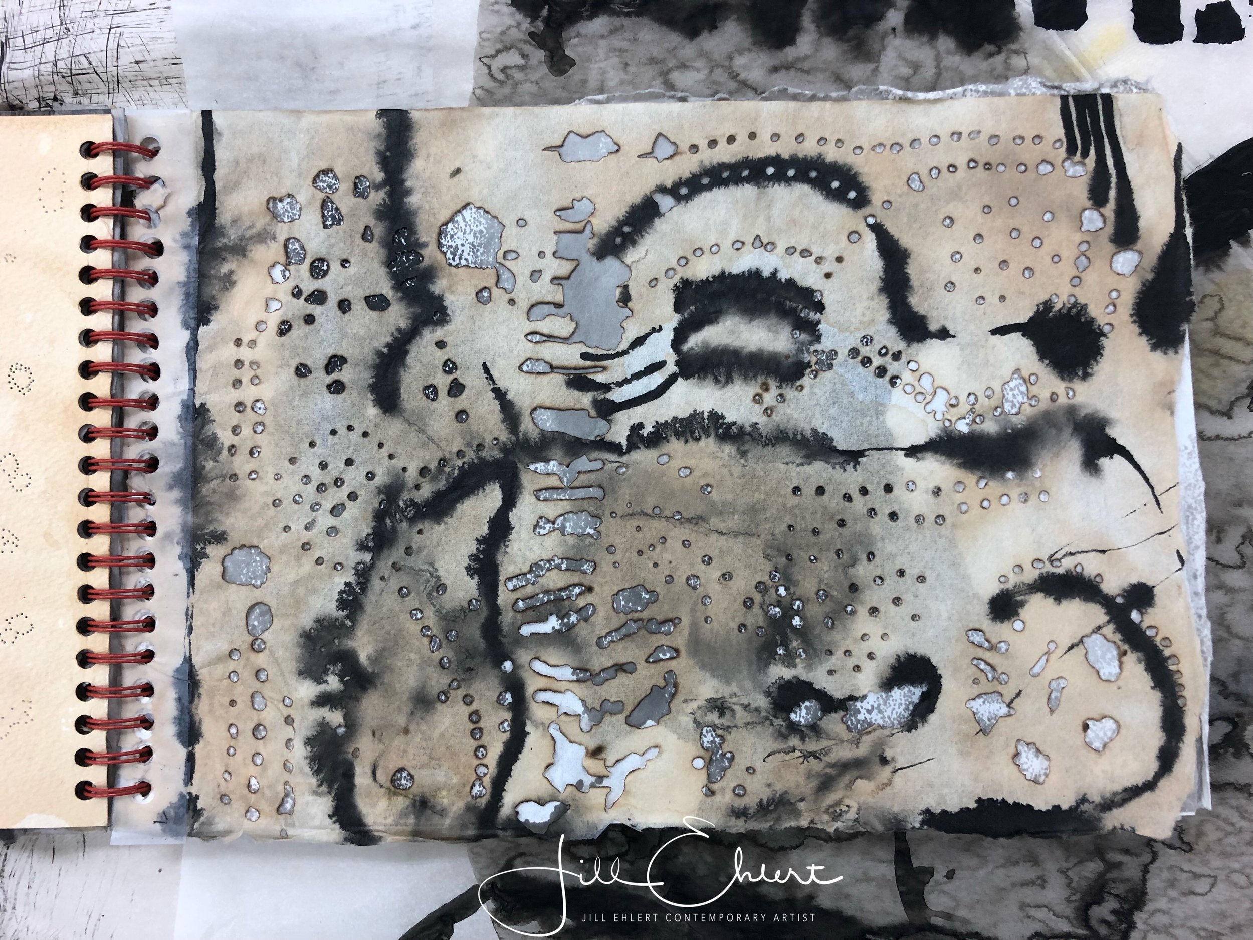 Tea stain, India ink, burned holes.