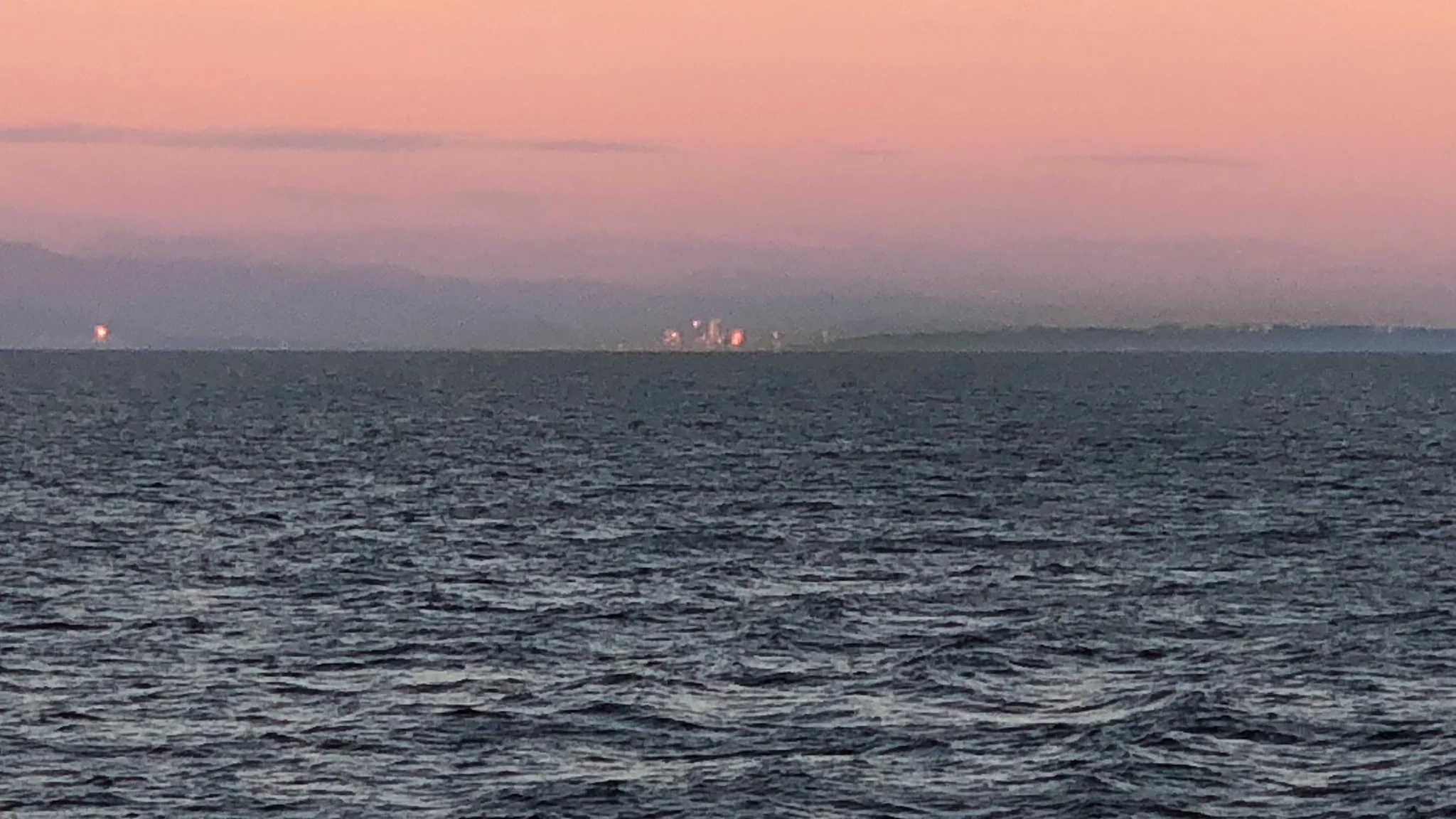 Skyline of Vancouver as we are leaving with the sunset reflected into the sky.