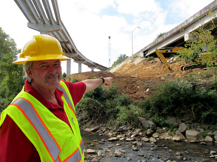 Georgia Department of Transportation employee points to the site of the future bridge.