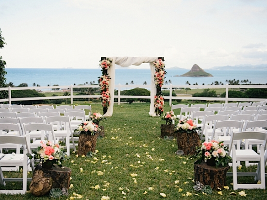  photo by Christie Pham  wedding location: Kualoa Ranch  ceremony arch and wood stump pedestals by Mood Event 