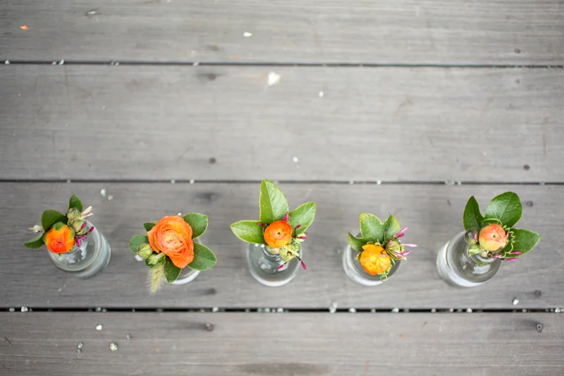 Bright and cheery boutonnieres with passion vine tendrils.