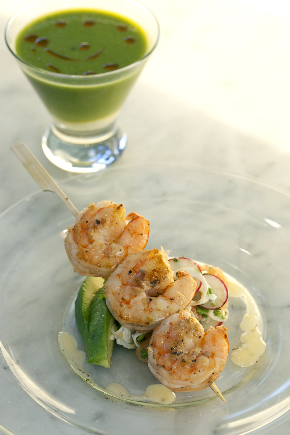 Purée of asparagus soup with goat cheese flan and harissa oil served with grilled wild shrimp with hearts of palm, avocado and grapefruit