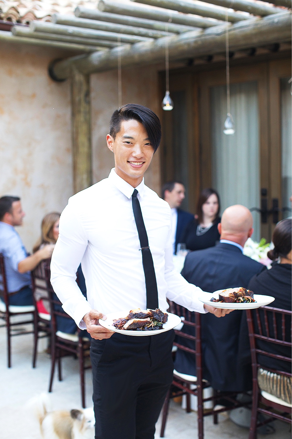 Server with sliced wedding cake