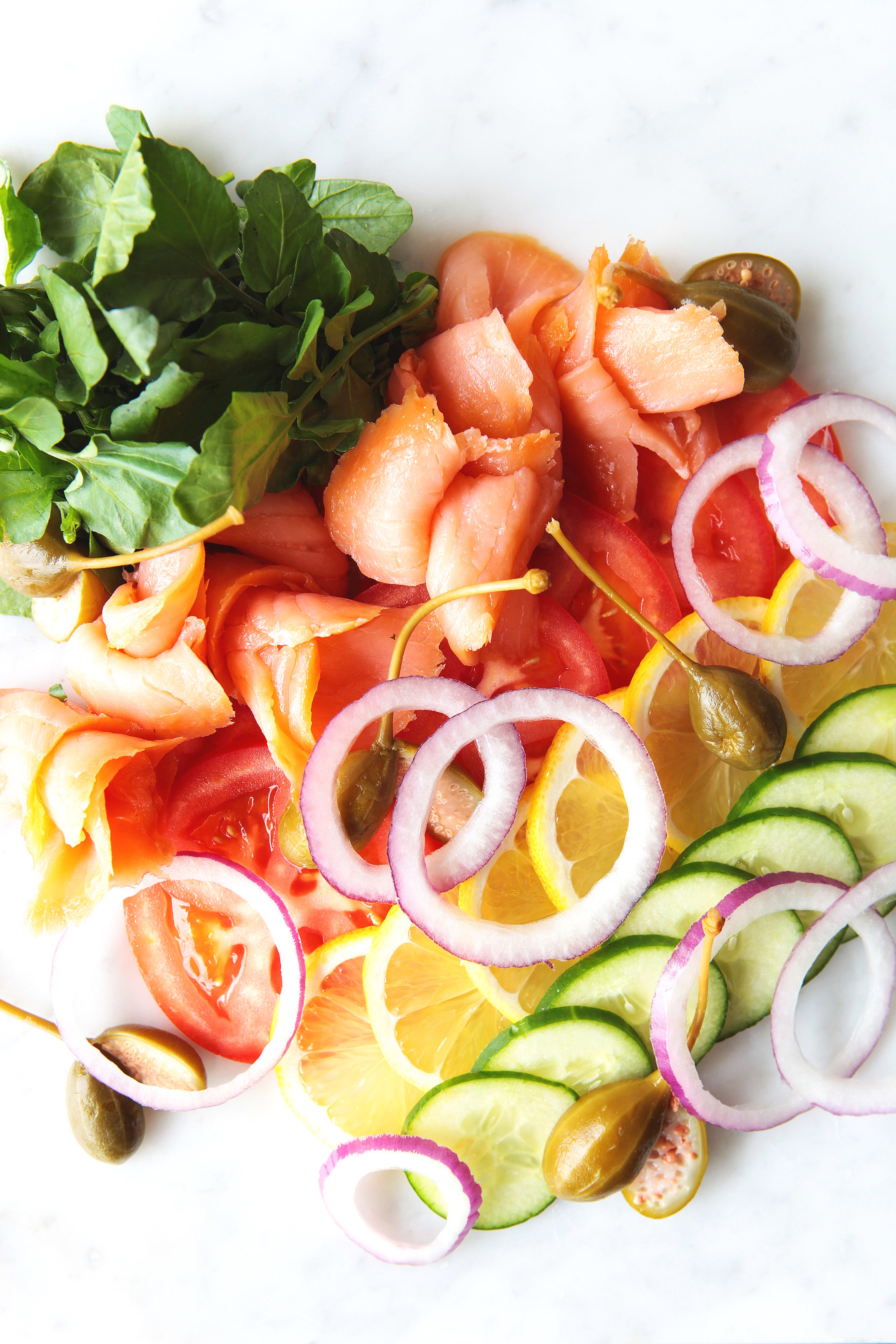 Smoked and cured lox with sliced tomato, cucumber, red onions and capers 