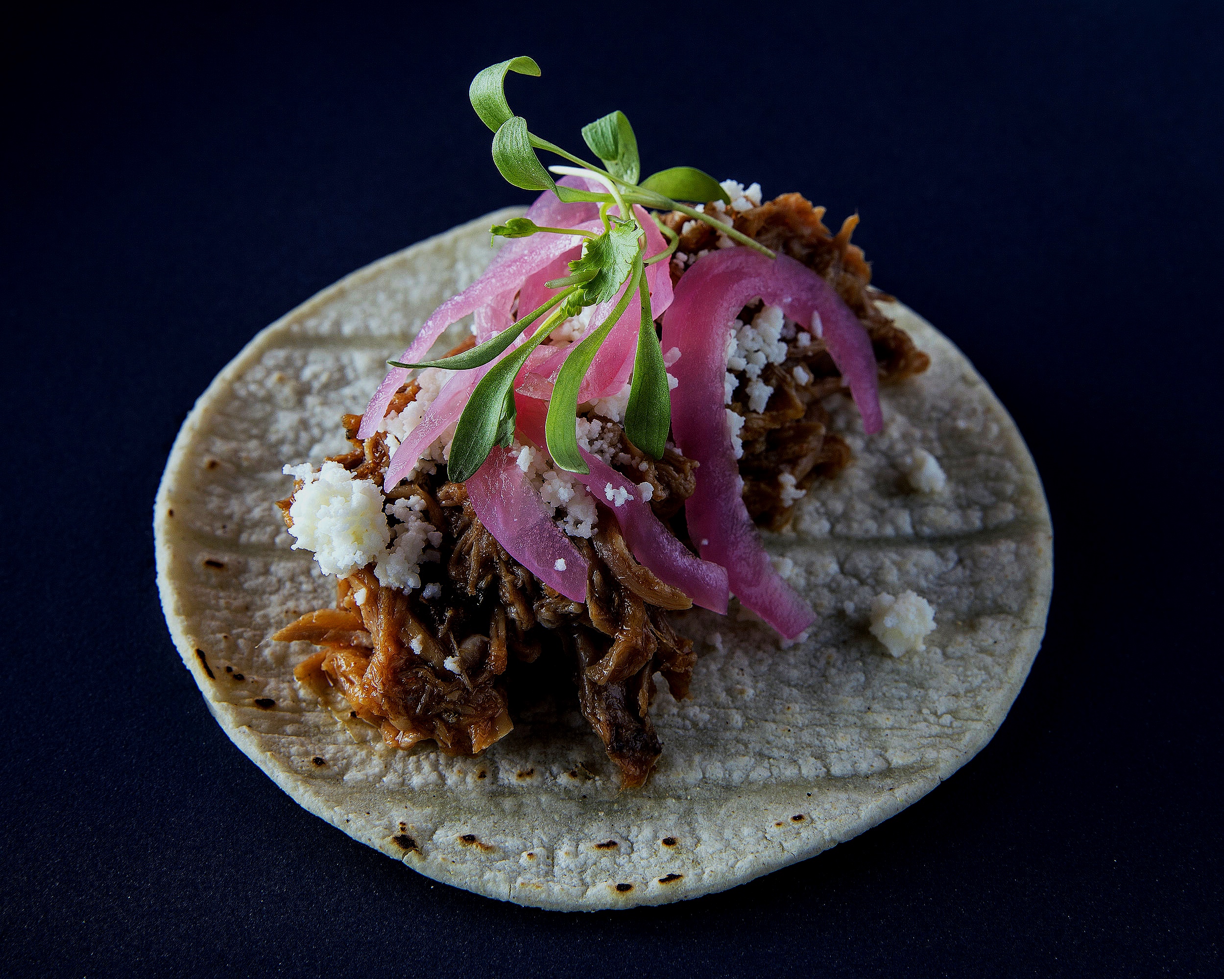 Pulled pork tacos with Cojita and pickled red onions