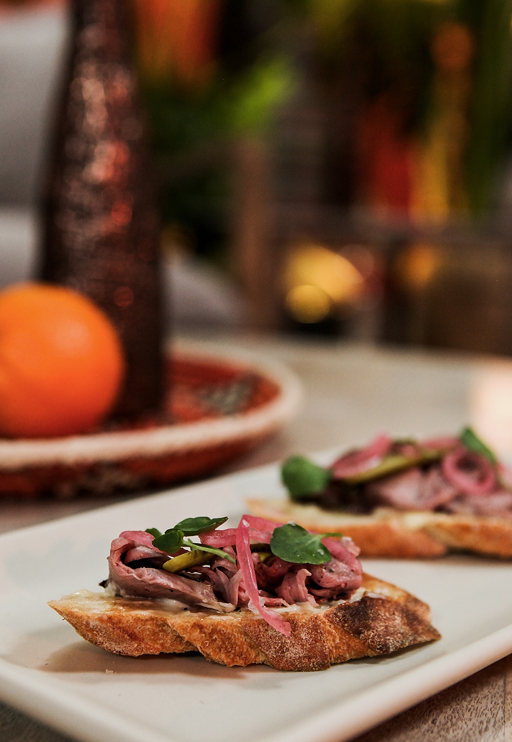 Crostini with slice beef and pickled red onion