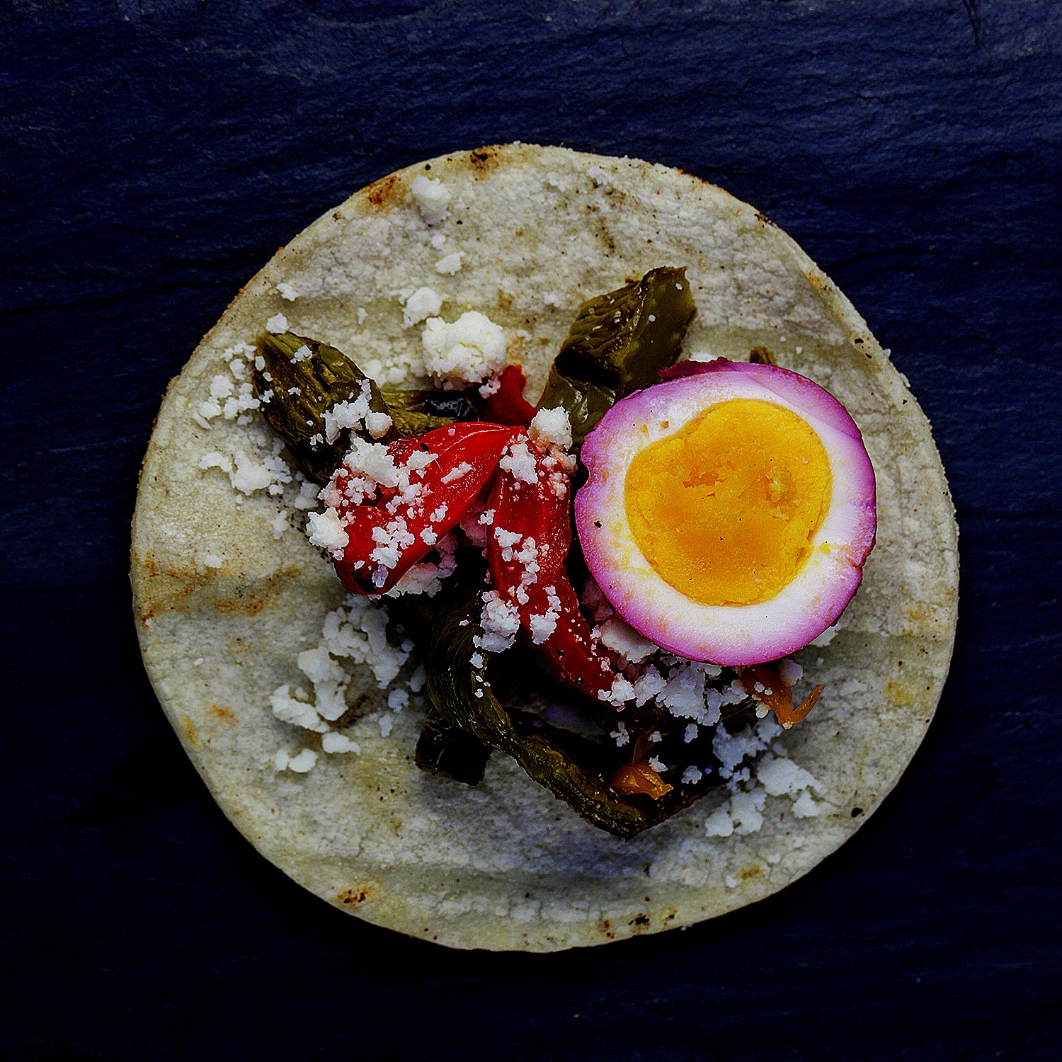Vegetable taco with roasted asparagus and red pepper, medium boiled beet egg and cojita 