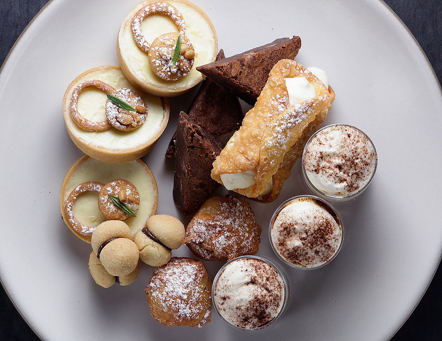 Dessert plate with brownies, tarts, cookies and canolis