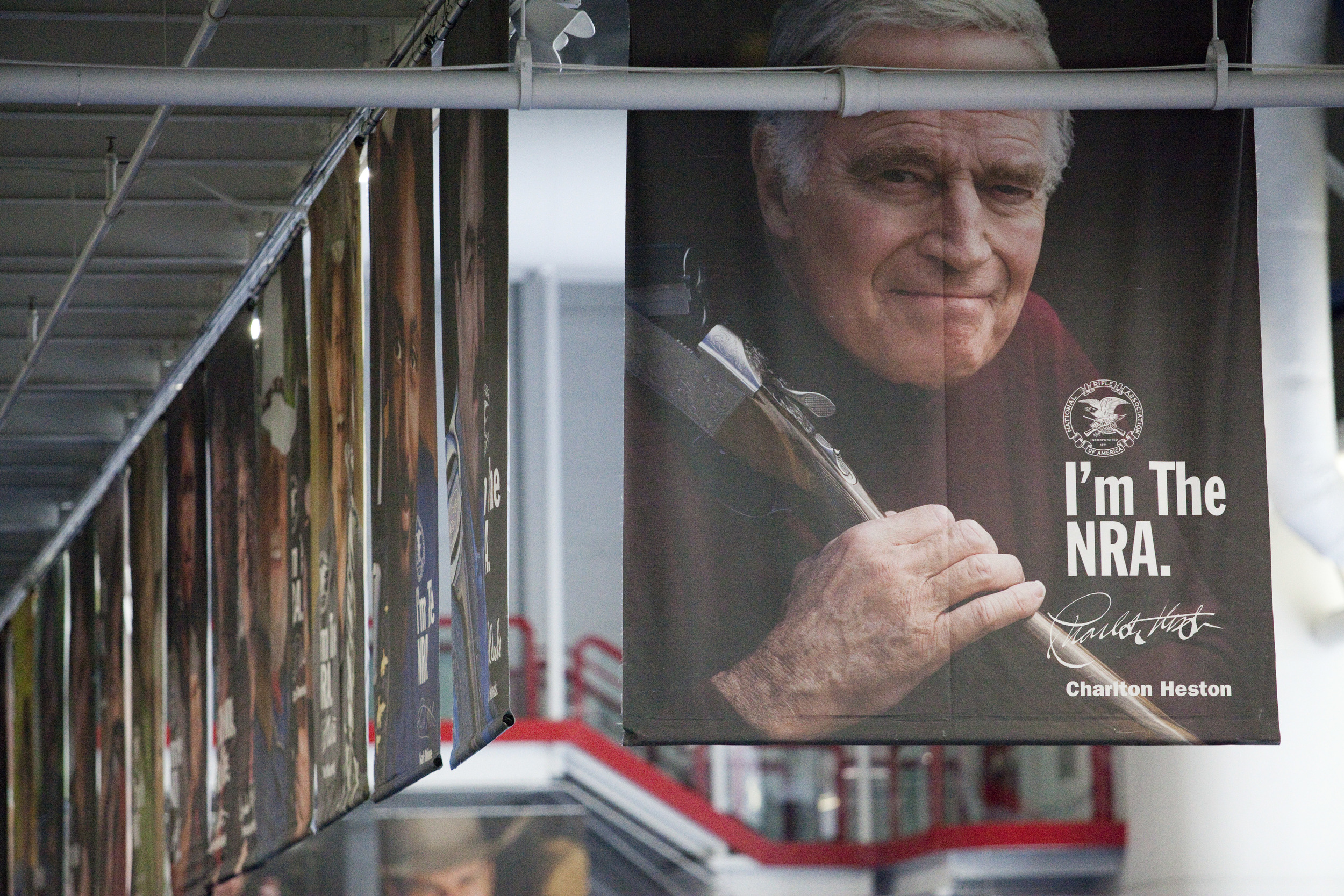  A poster of Charlton Heston, along with other celebrity members, hangs in the George R. Brown Center at the 2013 National Rifle Association Meeting and Exhibits May 2, 2013 in Houston. 