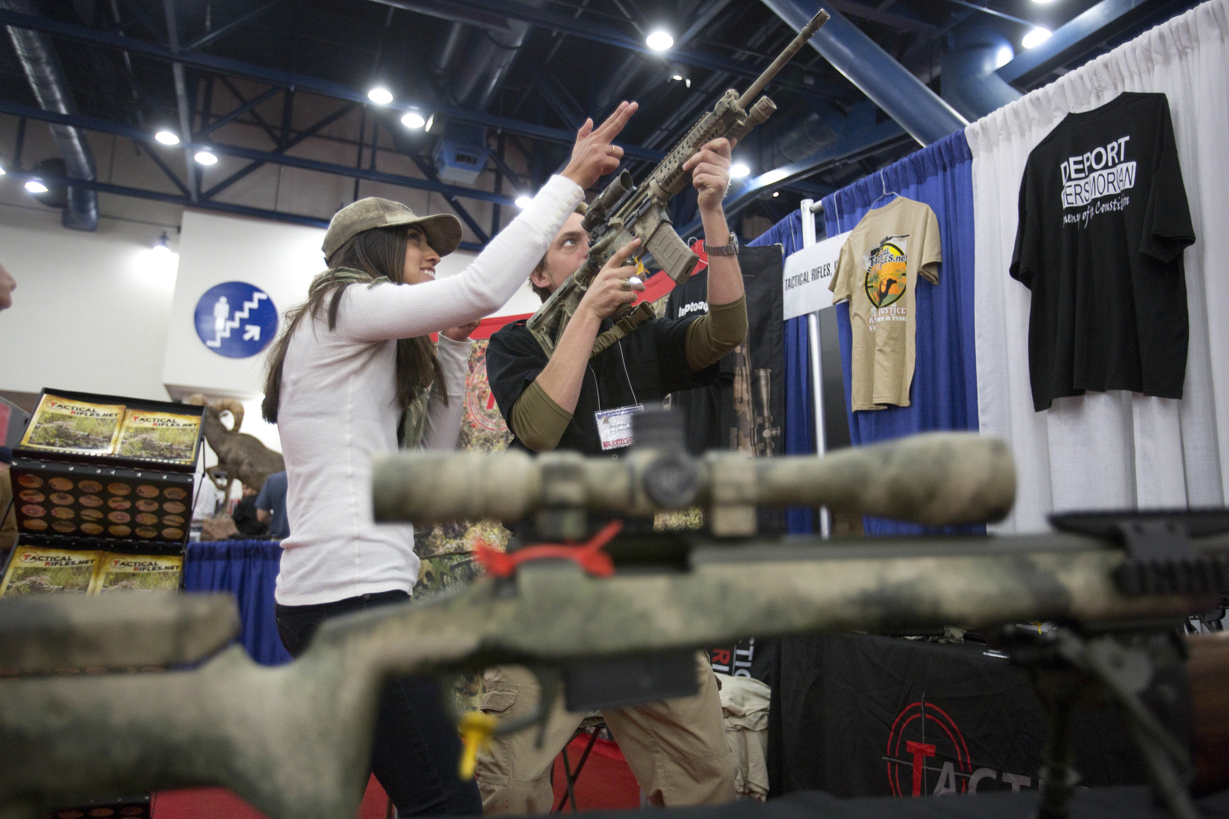  Vianne Euresti, left, and Jack Dougherty, of Tactical Rifles, looks down the sight of a M-4 at the 2013 National Rifle Association Meeting and Exhibits May 3, 2013 in Houston. 