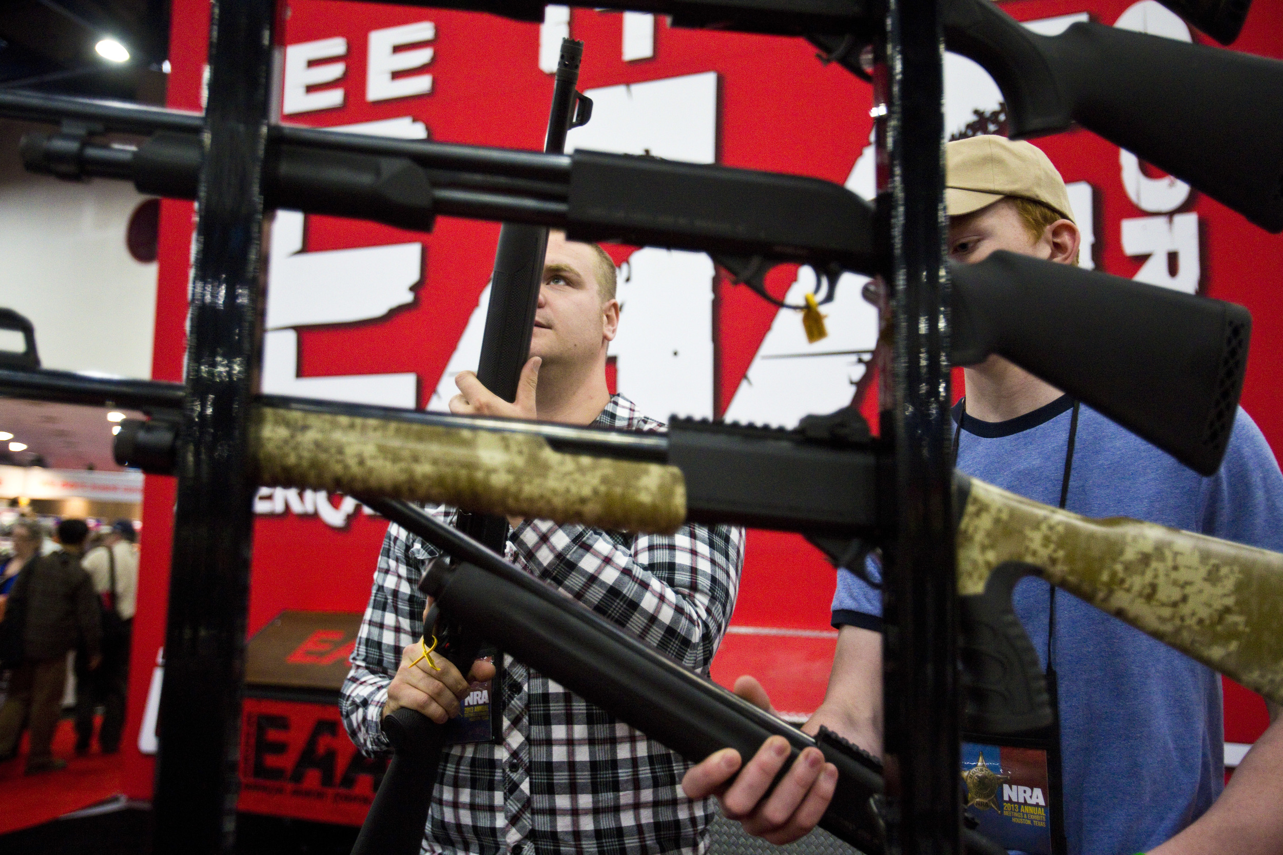  David Goodrum, left, and brother Matt, look at SAR semi automatic home defense 12 gauge shotguns at the 2013 National Rifle Association Meeting and Exhibits May 4, 2013 in Houston. 