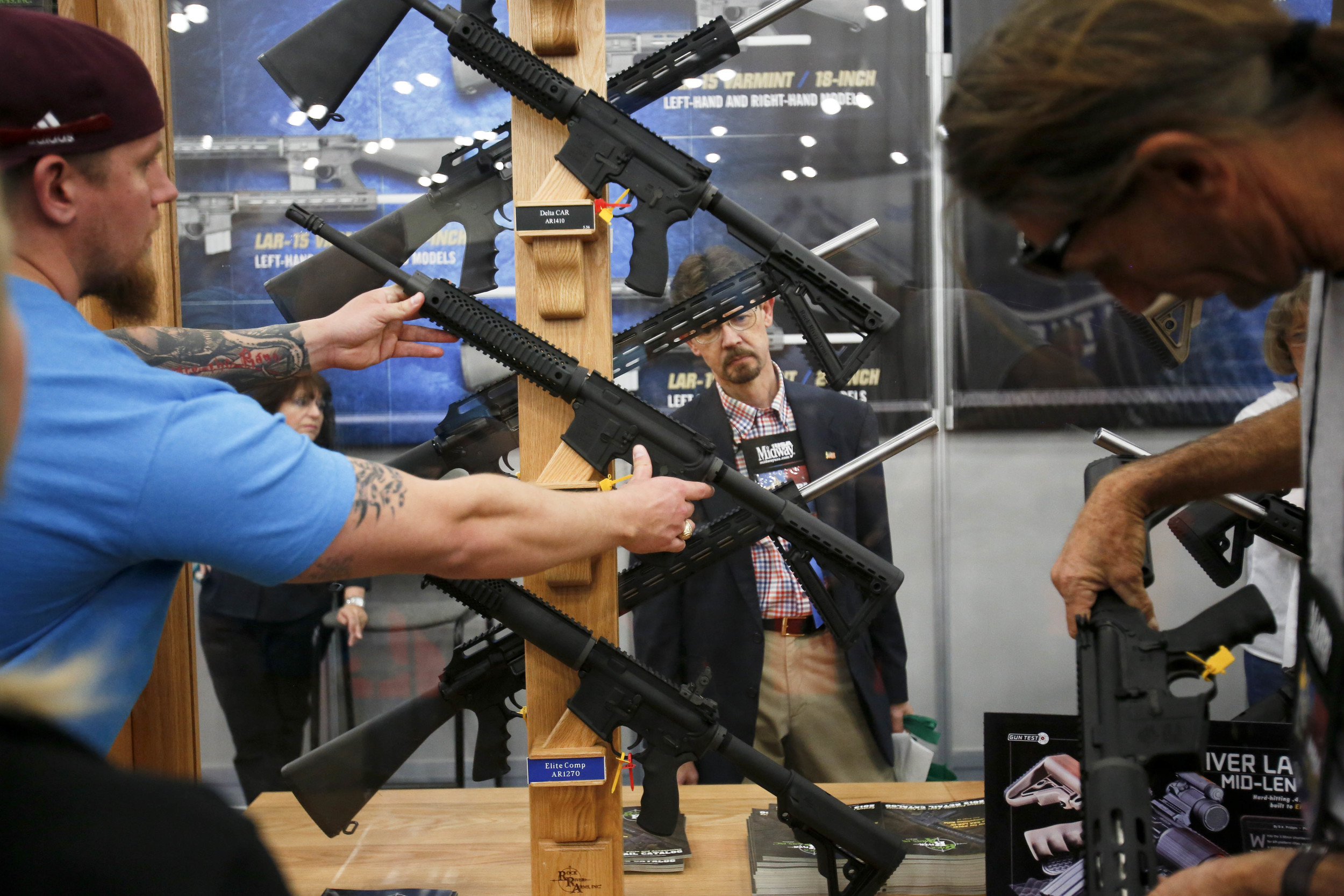  Attendees look at AR15 rifles at the 2013 National Rifle Association Meeting and Exhibits May 4, 2013 in Houston. 