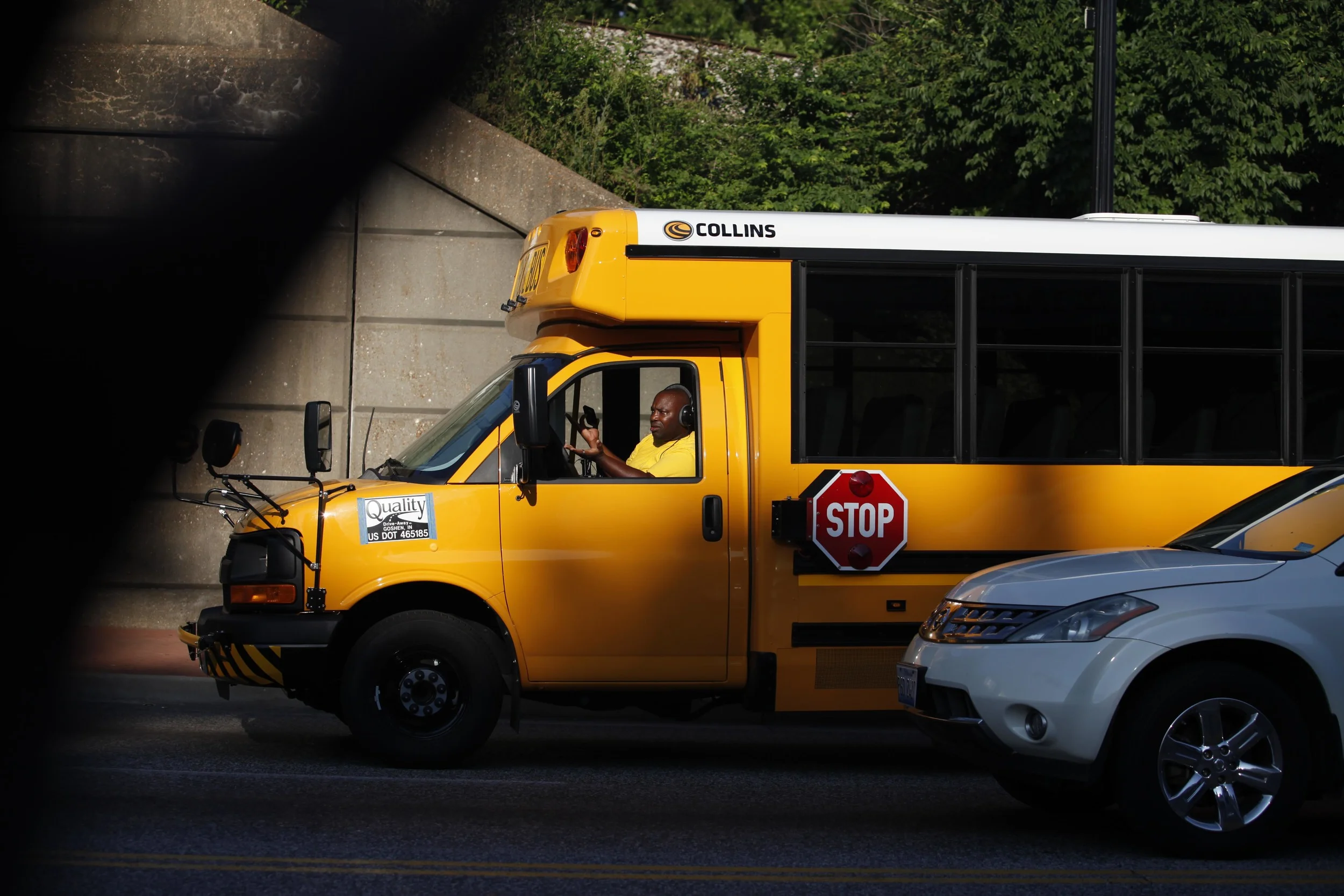 A school bus driver gestures while waiting at a stoplight August 19, 2014 in downtown Ferguson, MO.