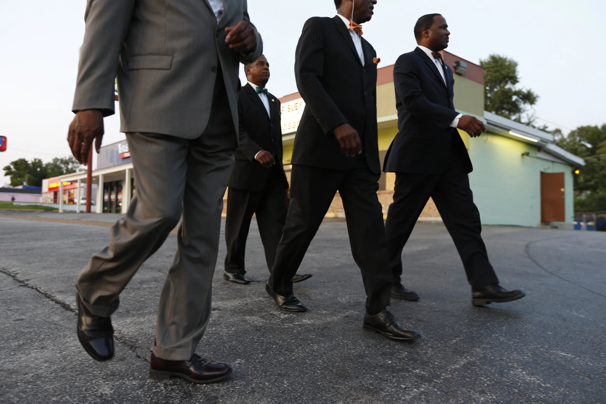 Members of the Nation of Islam walk down W. Florissant Ave. August 19, 2014 in Ferguson, MO.