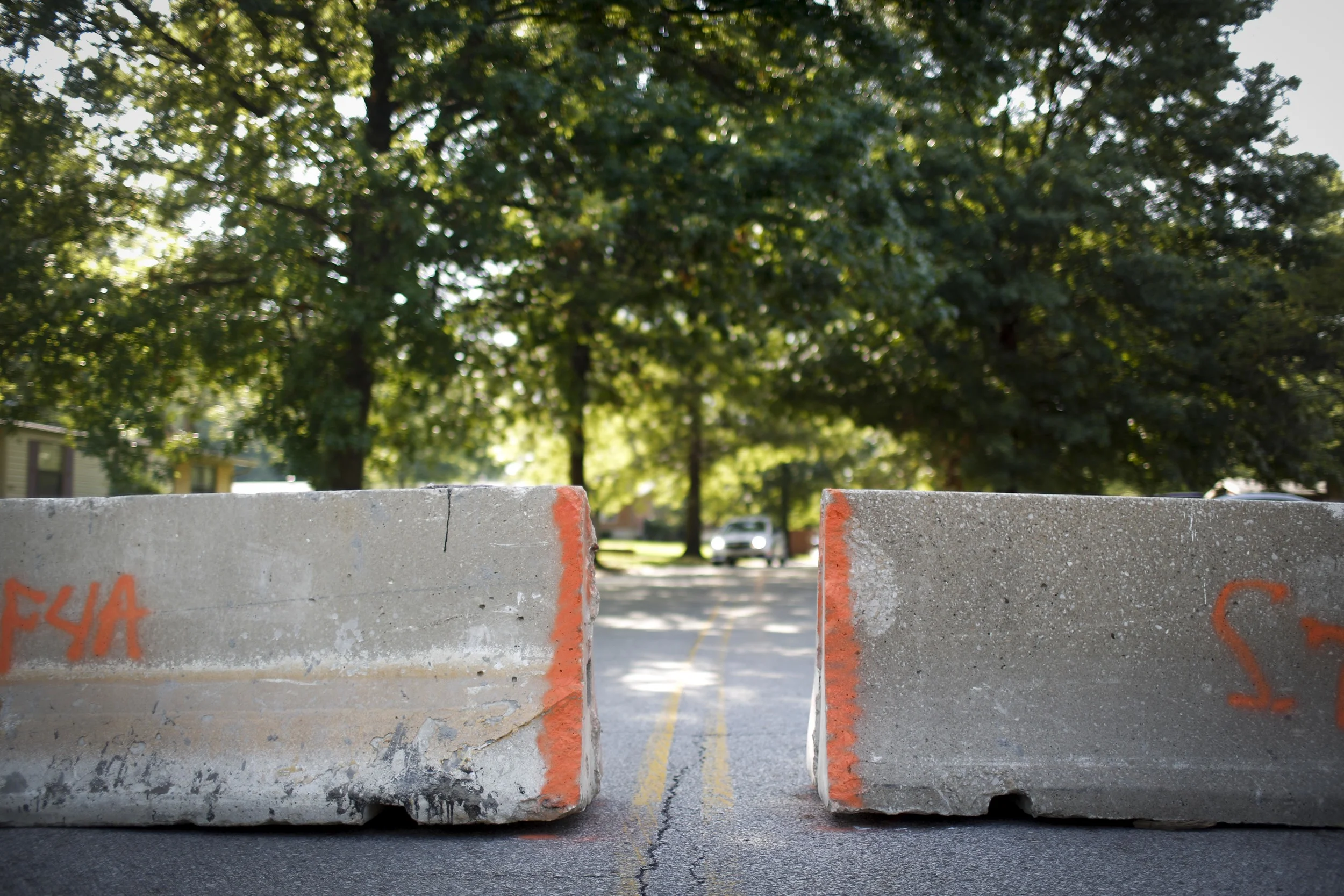 Road barriers stand at the end of Canfield Road, the same street Michael Brown was shot and killed on by a Ferguson police officer August 20, 2014 in Ferguson, MO. Some residents have complained that they're not able to get to their homes and don't know shortcuts that law enforcement presumes they know. Many cars were observed by the photographer driving through adjacent yards to get past the barriers with ease.