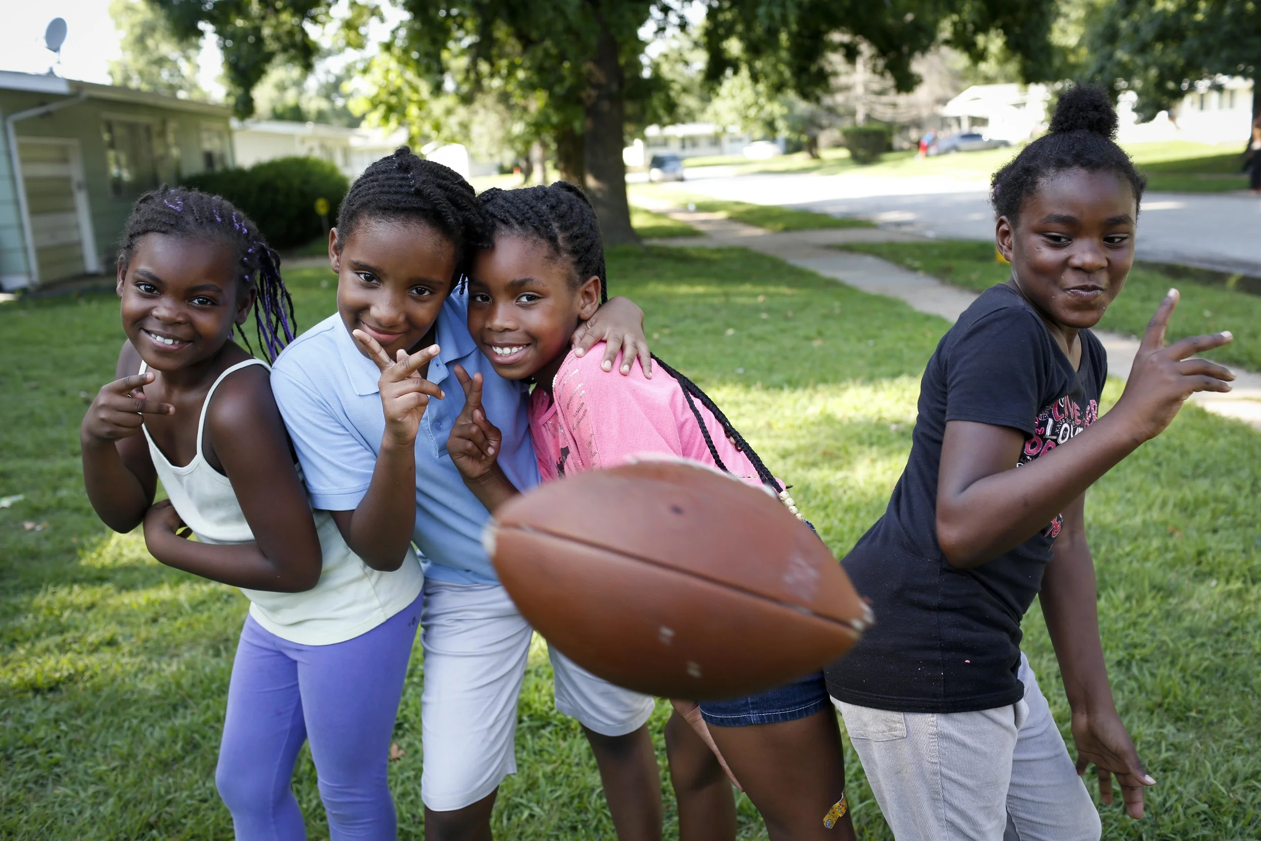 Jamyla Bolden (far left), then 8, is shown in a photo from Aug. 20, 2014. She posed with Trice Johnson (center left), 8, (center left), Destiny Sonnier (center right), 8, and Rayell Hickman, 8, along Ellison Drive in Ferguson. The kids were in a yard just around the corner from where Michael Brown was shot and killed by a Ferguson police officer. Bolden was killed by a drive-by shooter while doing homework on her mother's bed August, 28, 2015.
