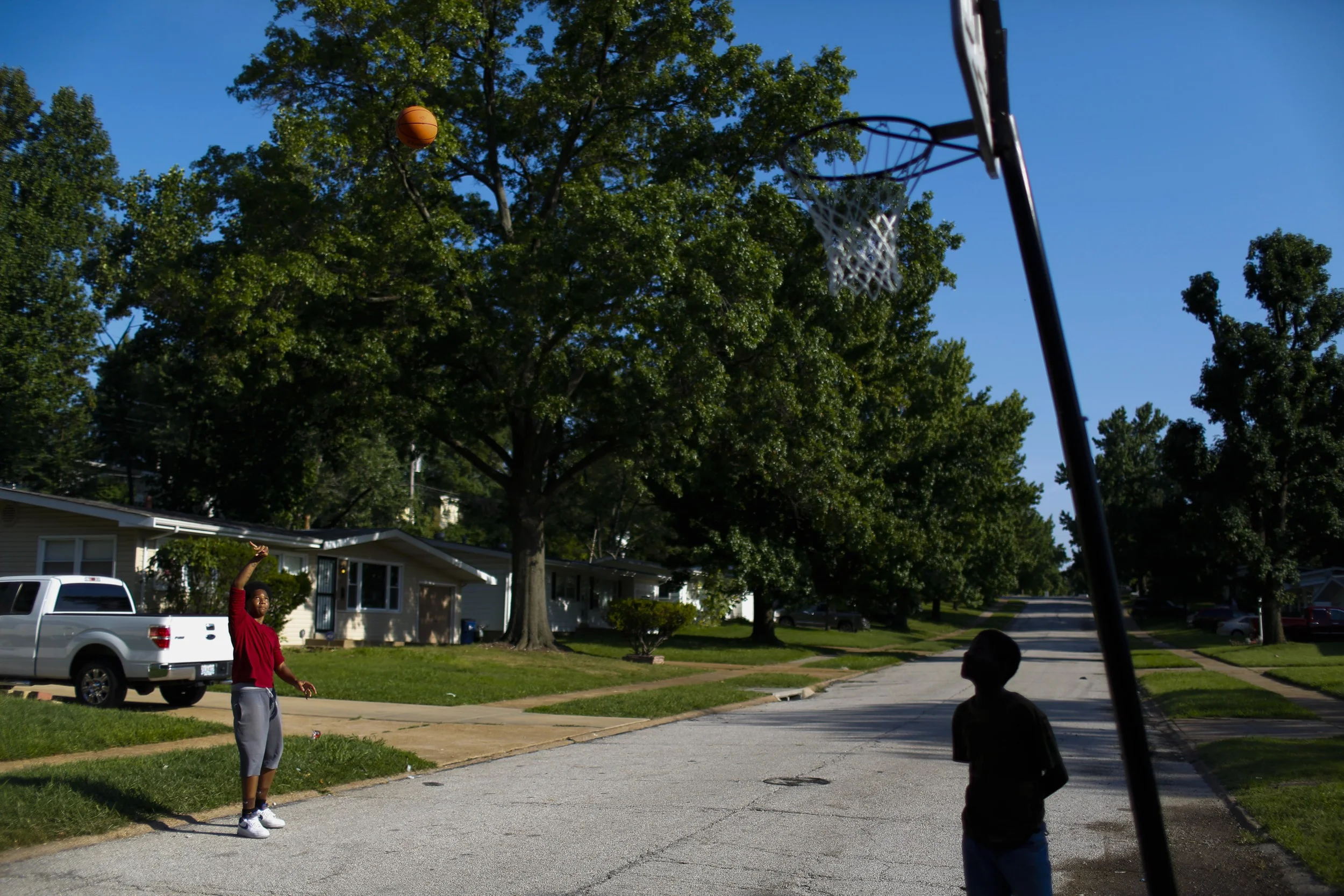 Two kids play basketball on Ellison Road, just around the corner from where Michael Brown was shot and killed by a Ferguson police officer. August 20, 2014 in Ferguson, MO.