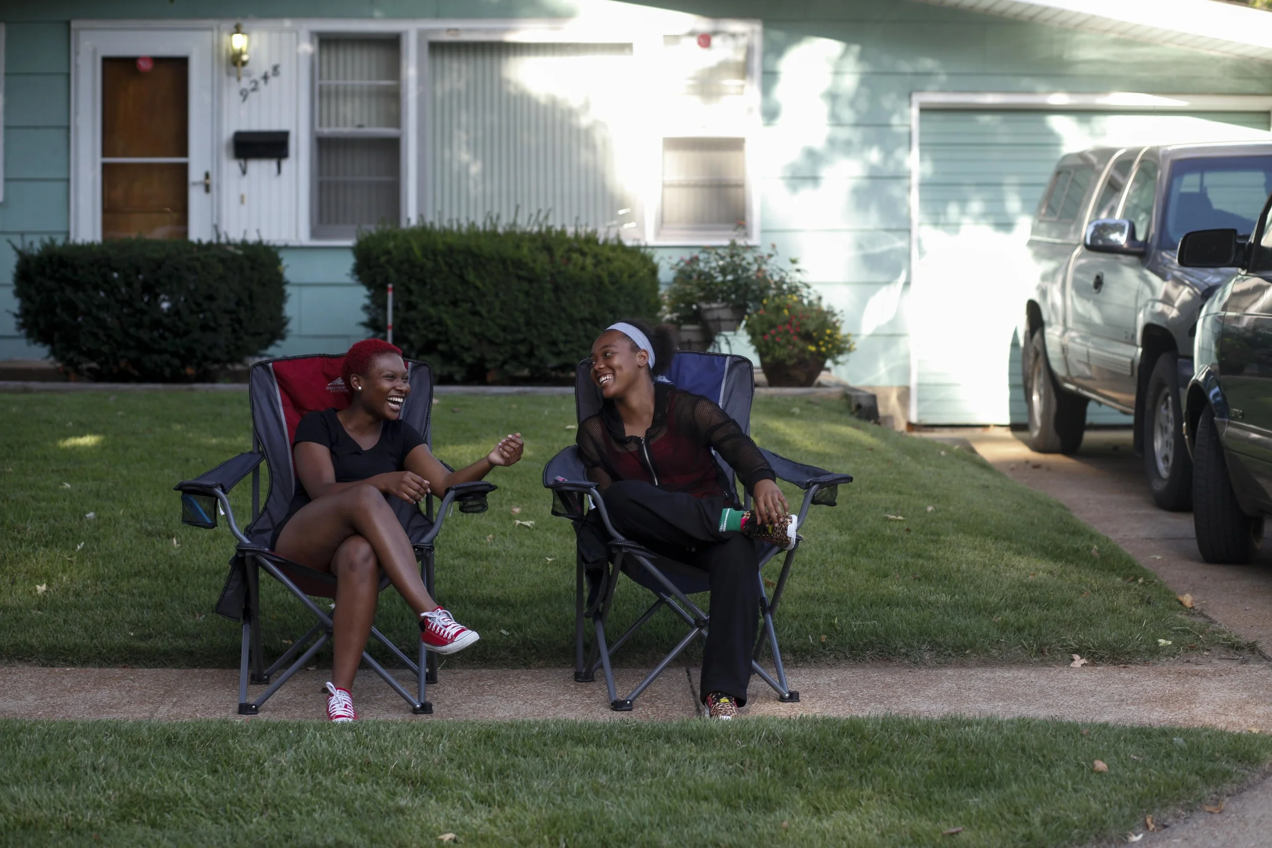 Markquetta Powell, left, and Deborah Austin chat on the sidewalk August 20, 2014 in Ferguson, MO. The two were chatting just around the corner from where Michael Brown was shot and killed by a Ferguson police officer.