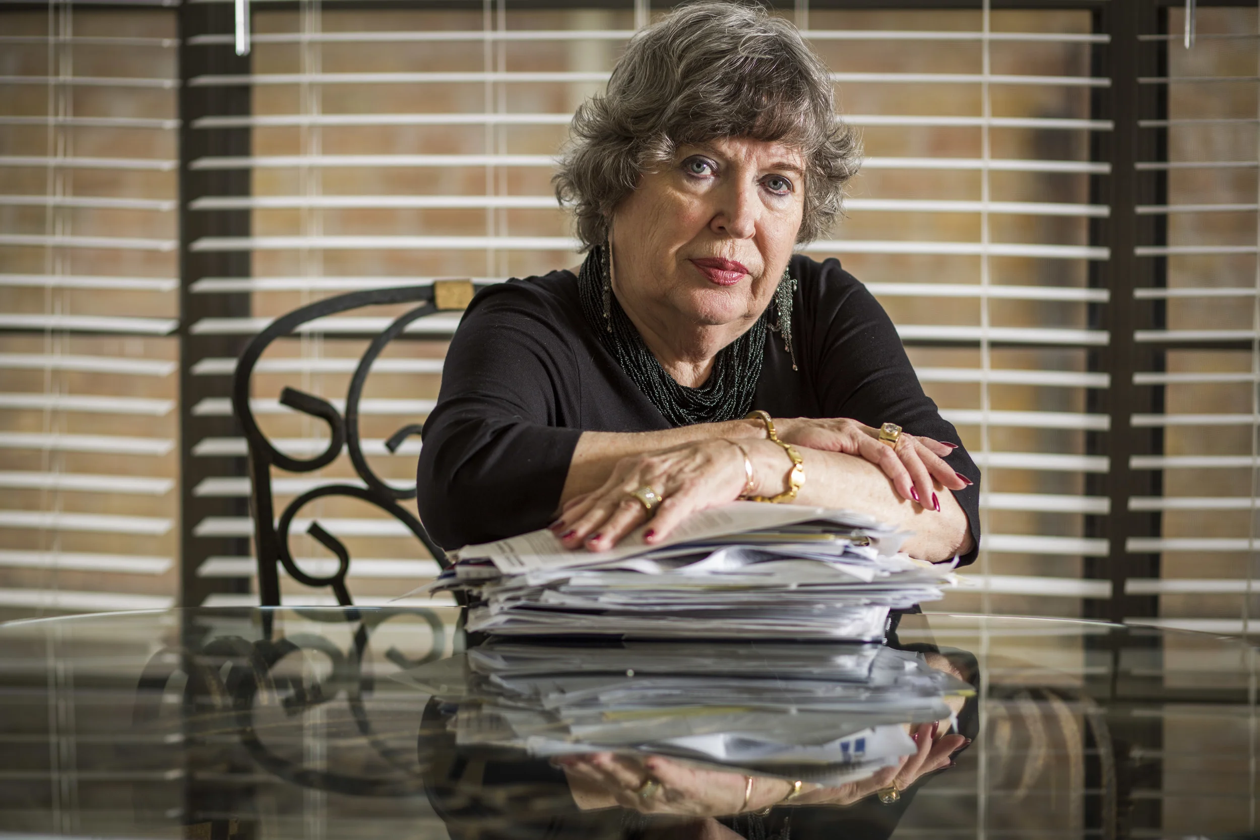 Barbara Beard by a stack of paperwork connected to her dispute with medical providers Feb. 5, 2014 in Katy, TX. Beard's husband was discharged from a long-term hospital after a 23 day stay to rehab following a botched knee surgery, and later died.