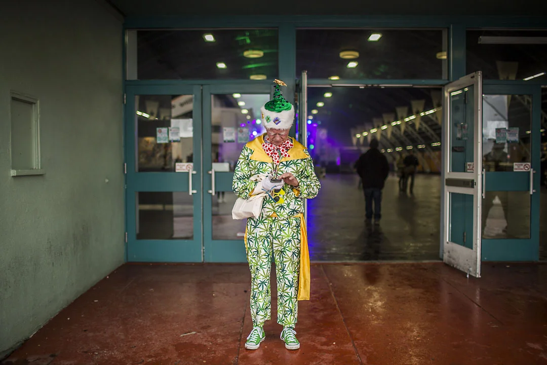 An attendee dials his cell phone at the Emerald Cup.