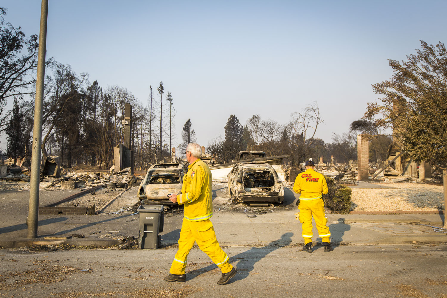  Cal Fire officials survey the damage of a devastating fire in the Coffey Park neighborhood Oct. 13, 2017 in Santa Rosa, CA. 