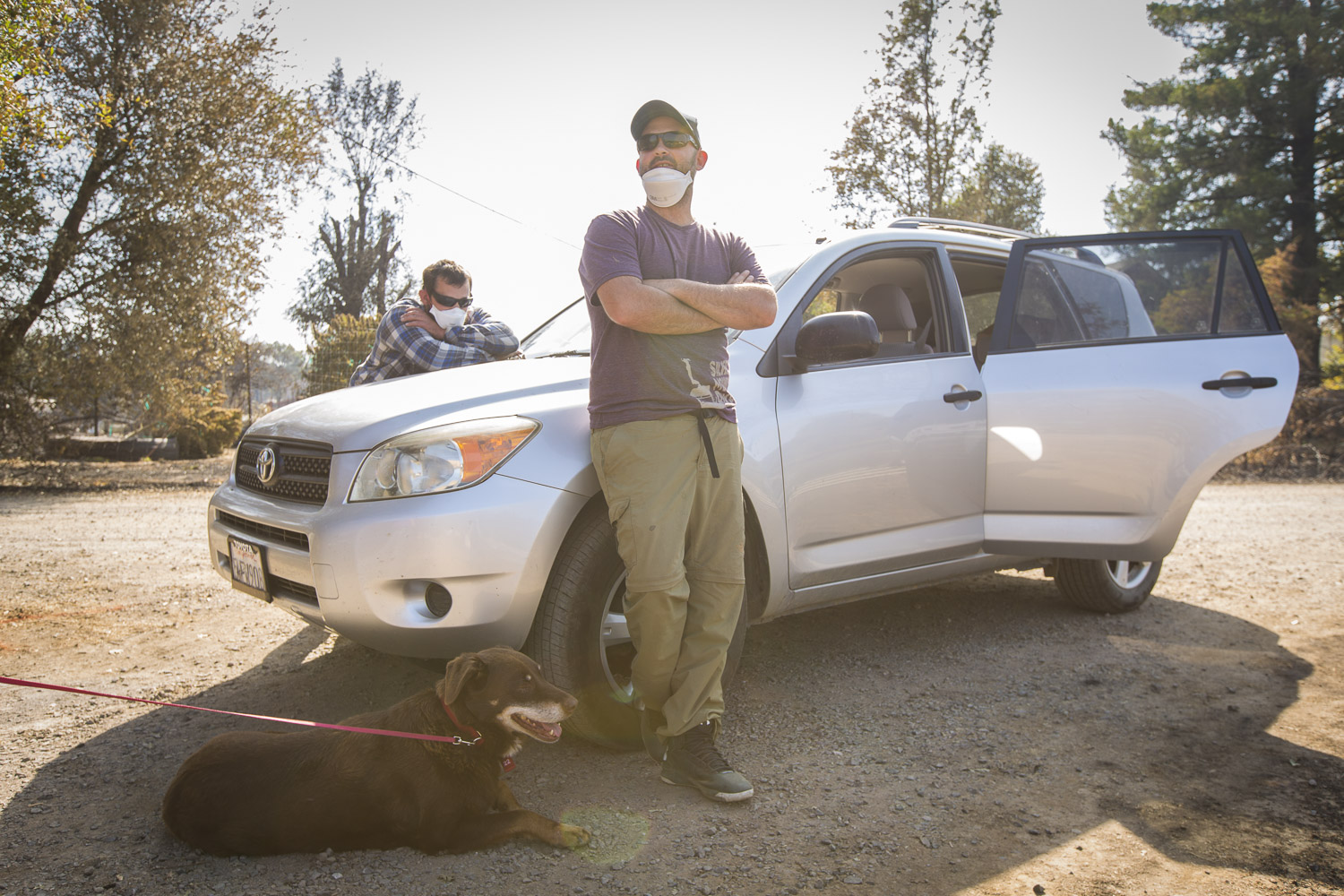  Eli Monroe, center, stands by his car he used to barely escape the Mendocino-area wildfire on his family's property Oct. 15, 2017 in Redwood Valley, CA. 