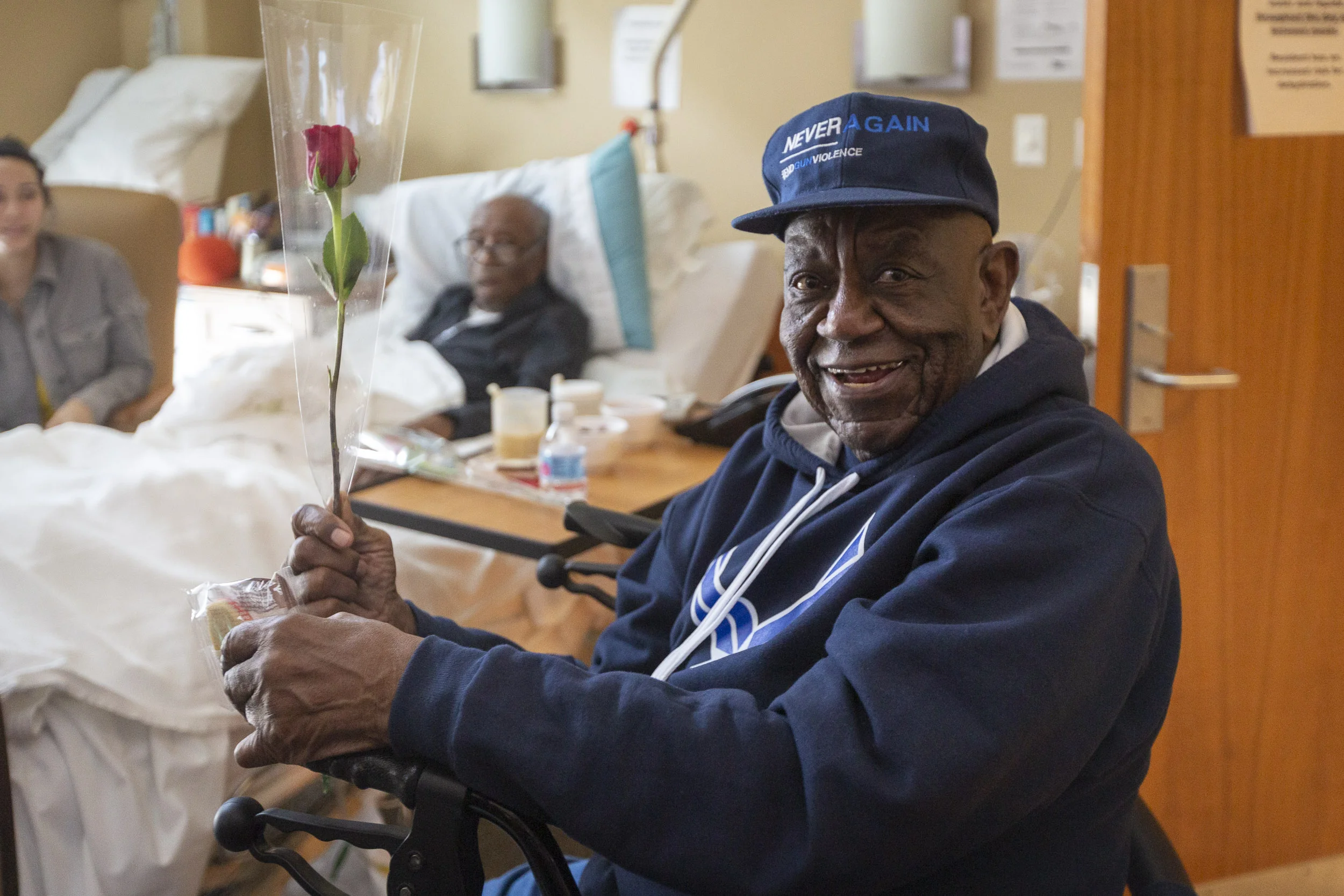 A military veteran receives a rose from 1-800-Flowers.com and a cookie from Cheryl's Cookies at the Armed Forces Retirement Home on Valentine’s Day on Thursday, Feb. 14, 2019 in Washington, DC.