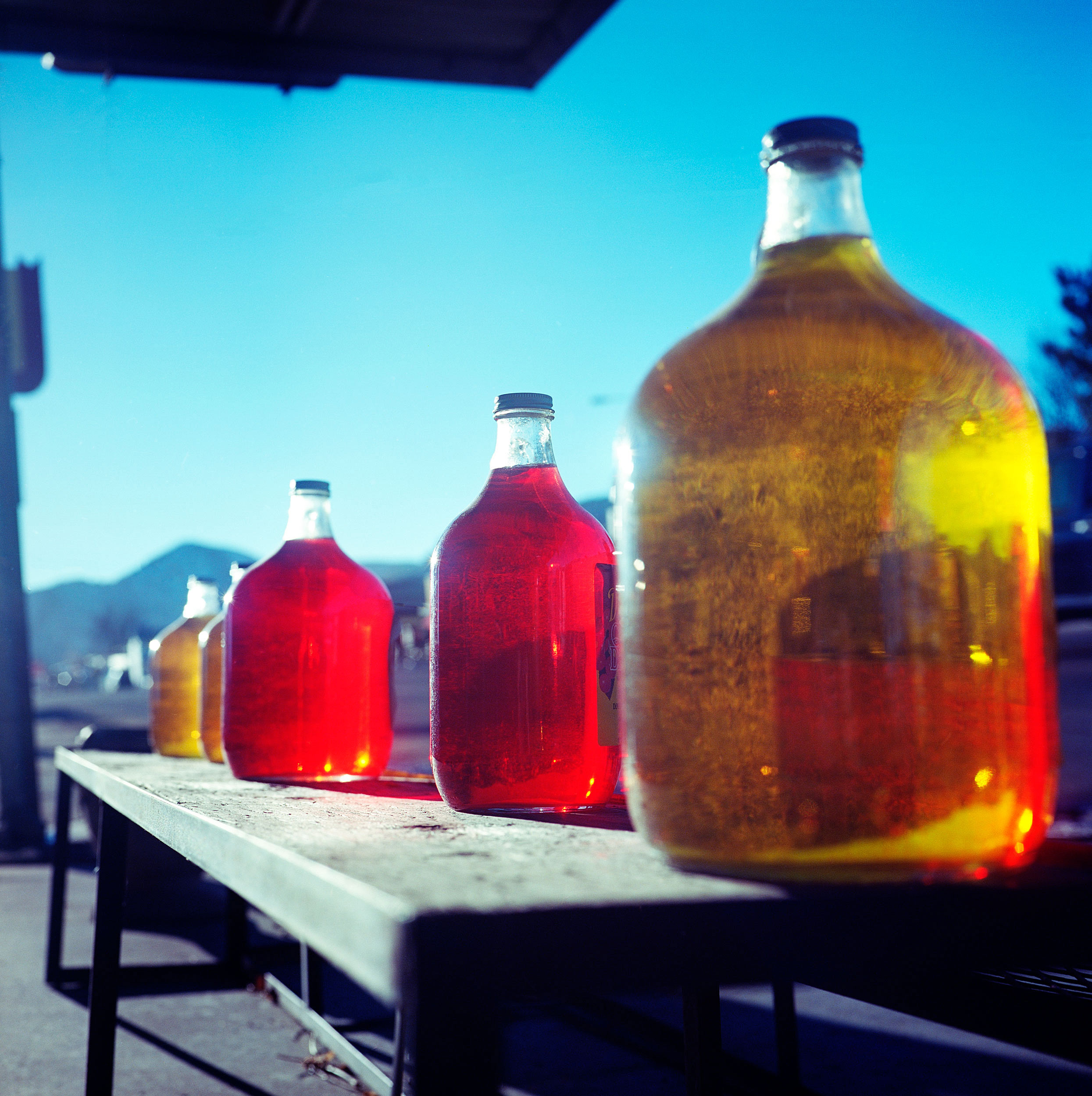  Cañon City, Colorado. These colorful cider bottles with the sun streaking through them caught my eye, but not just because of the color, but because they were very dusty. It boggled my mind that someone would put these bottles out for display to ent