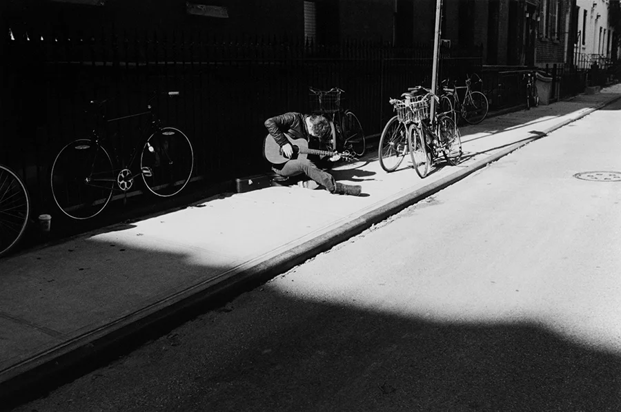 Man and His Guitar in the Village