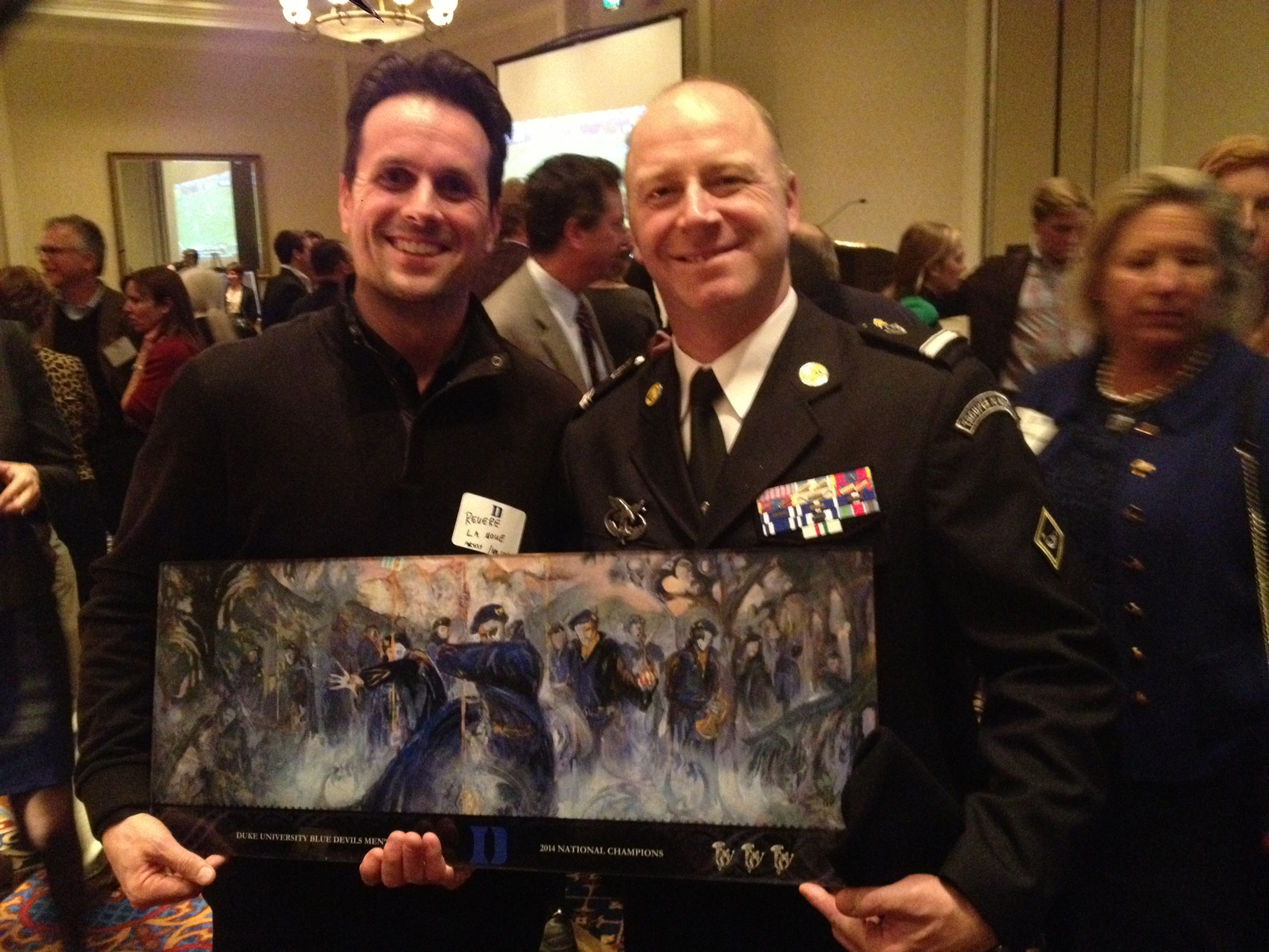 Major Lakomy was presented with a replica print of the Alpine Gothic installation commemorating Duke's 2014 Men's Lacrosse National Championship.
