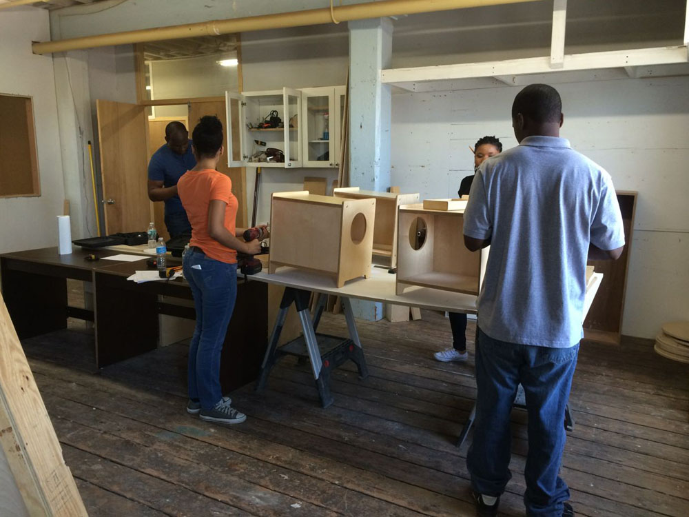 Building toy storage benches in their 'classroom'