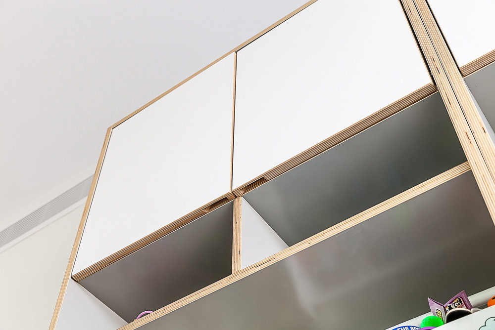 Bright room with a modern, minimalist hanging shelf design.